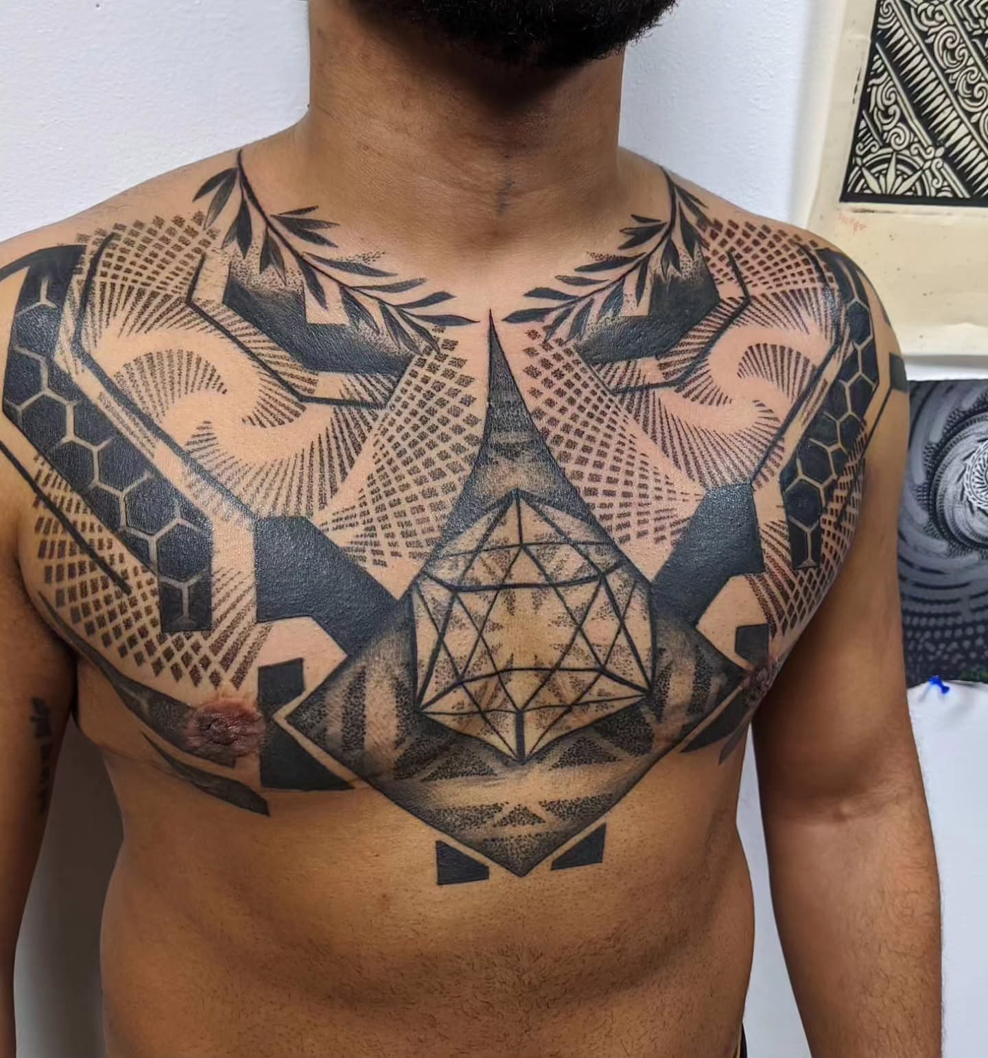 Geometric design geometric tattoo on the chest by Ed Gonzalez