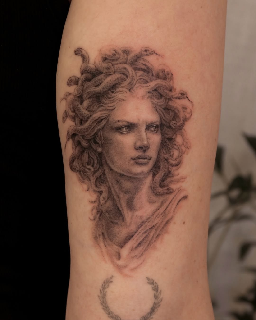 Medusa portrait realism tattoo on the forearm by Nicholas Solomon