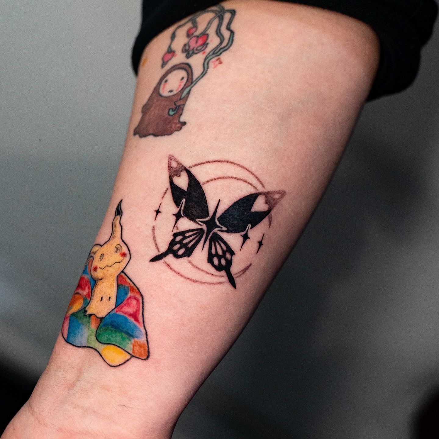 Butterfly and abstract shapes watercolor tattoo on the forearm by Kalin, Seattle, Washington