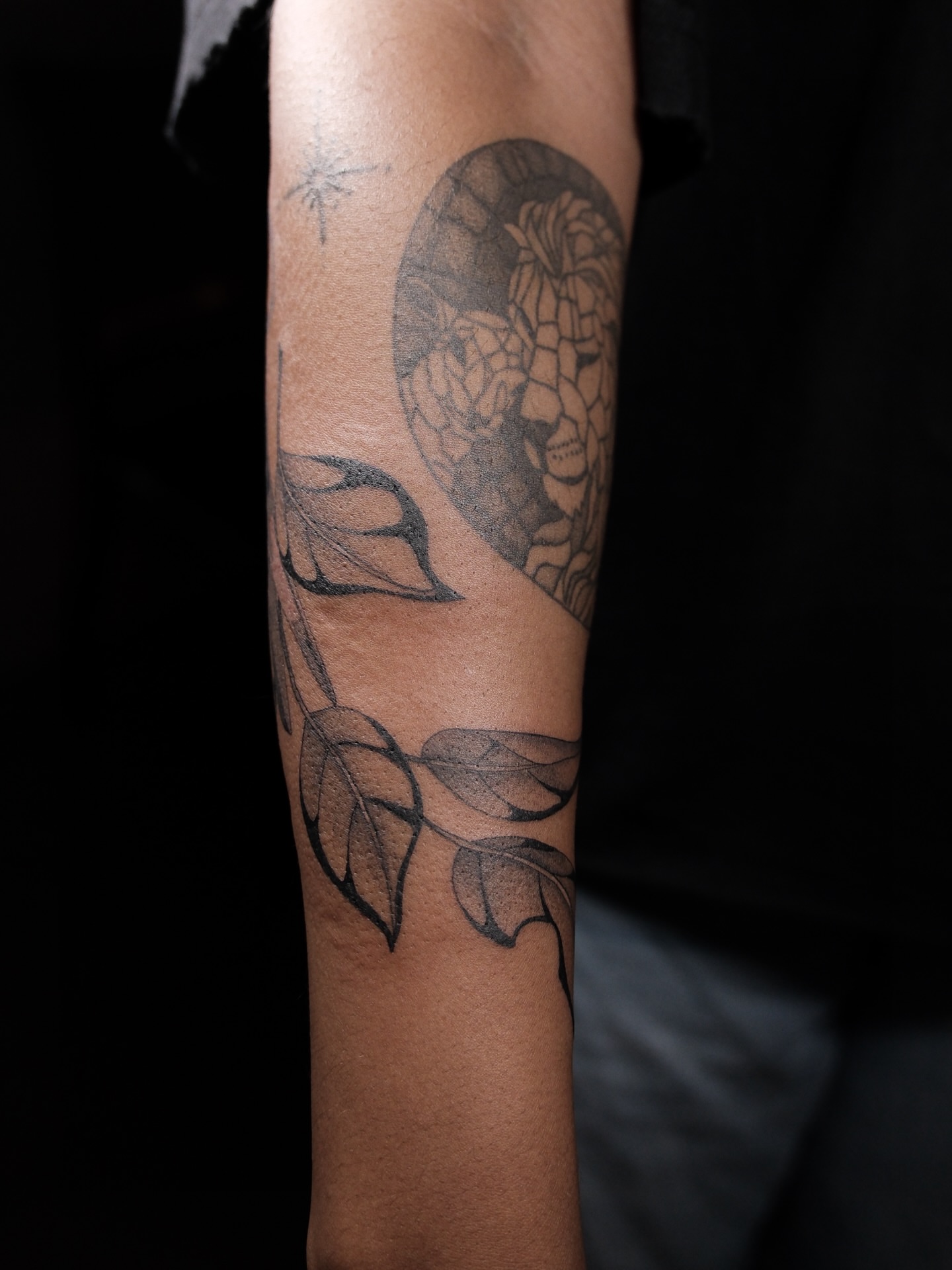 Flower and leaves black and grey tattoo on the forearm by Kiana Hope
