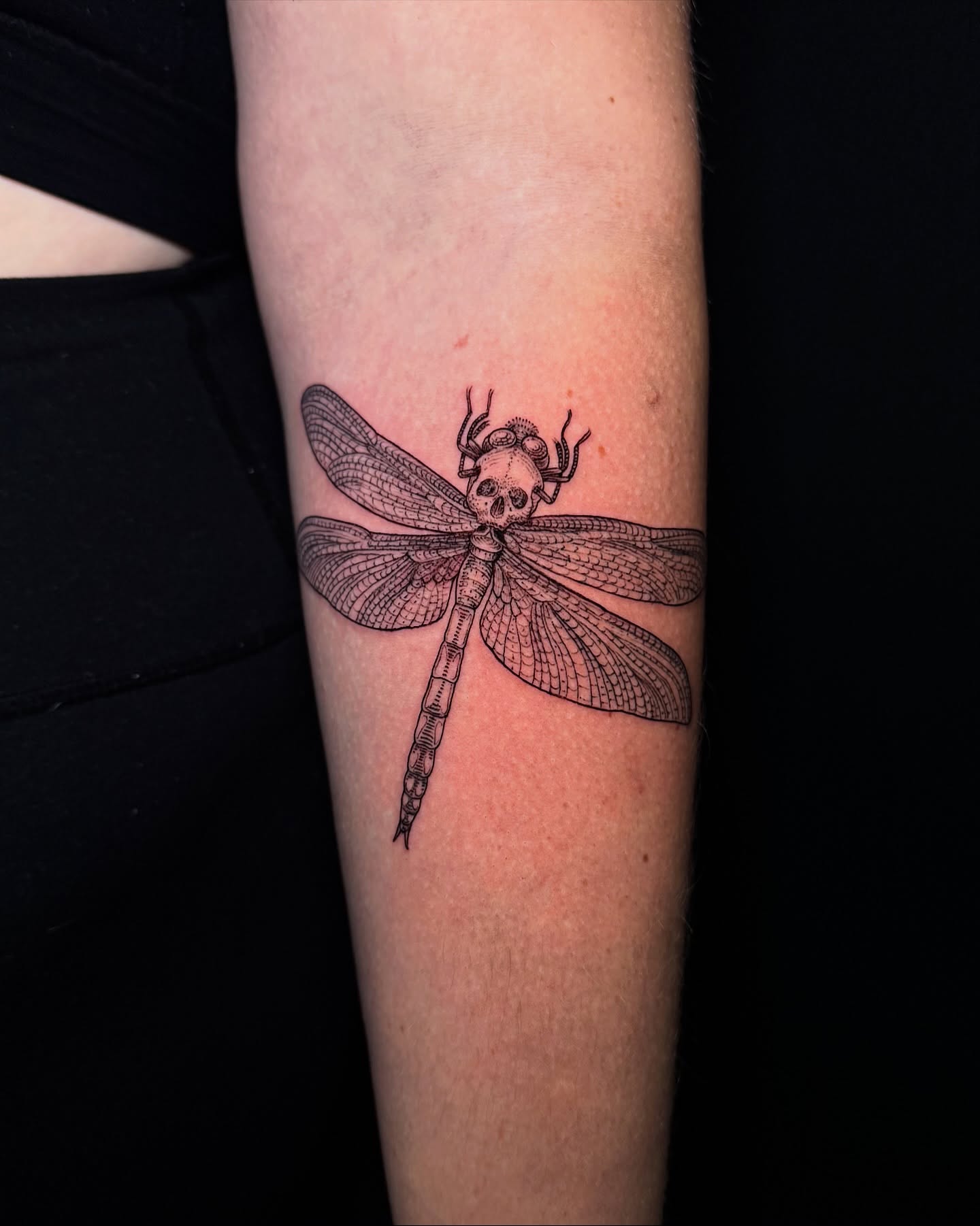 Dragonfly black and grey tattoo on the forearm by Landon Morgan