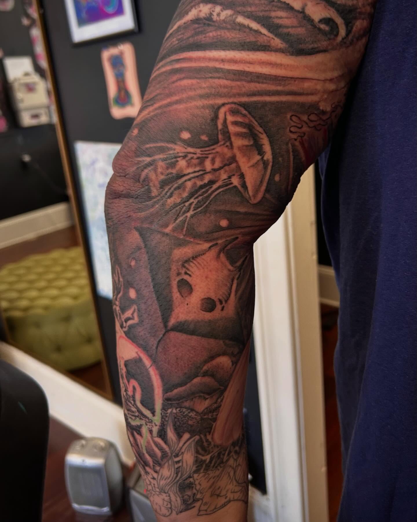 Abstract surreal landscape surrealism tattoo on the forearm by Jon Byrd