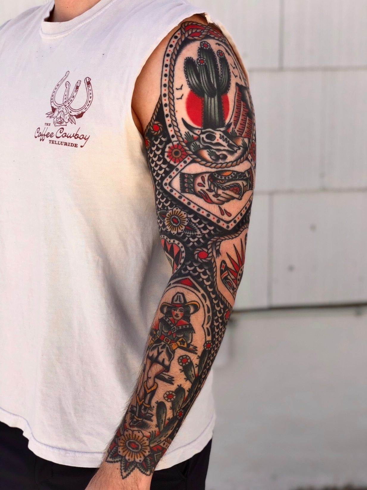 Western-themed sleeve American traditional tattoo by EVA Traditional Tattoos