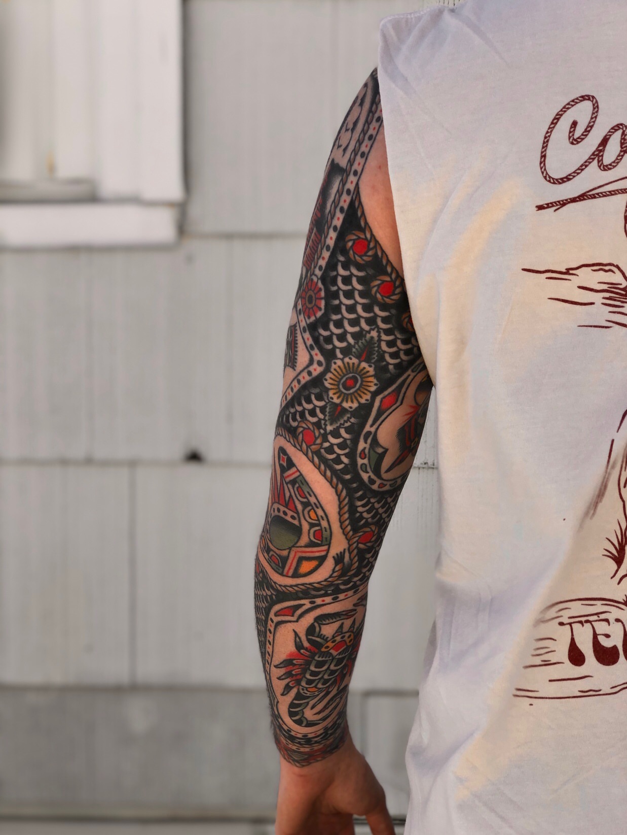 Dragon and floral patterns American traditional tattoo on the forearm by EVA Traditional Tattoos