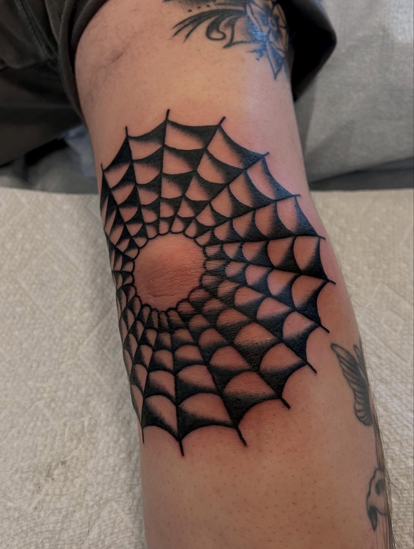 Spider web geometric tattoo on the forearm by Christian Lasyone