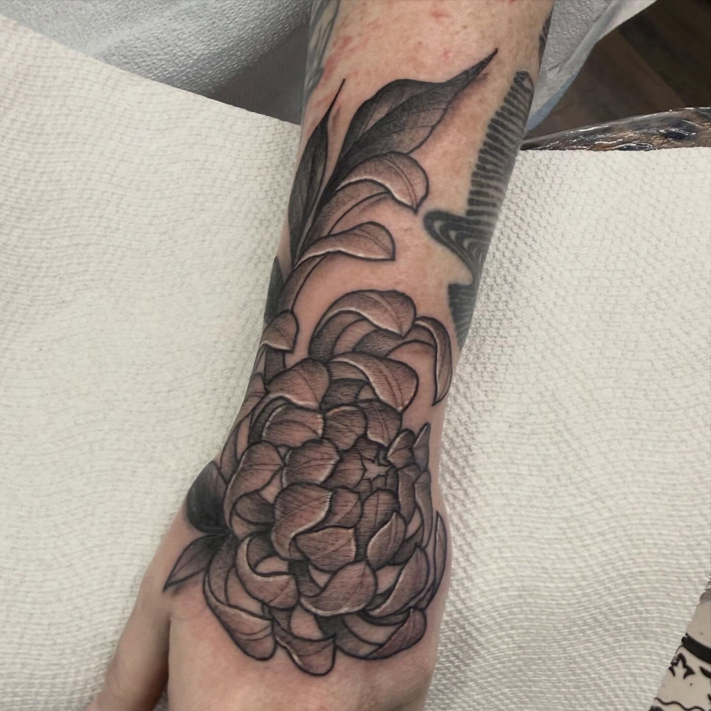 Flower black and grey tattoo on the forearm by Dameetra Davis