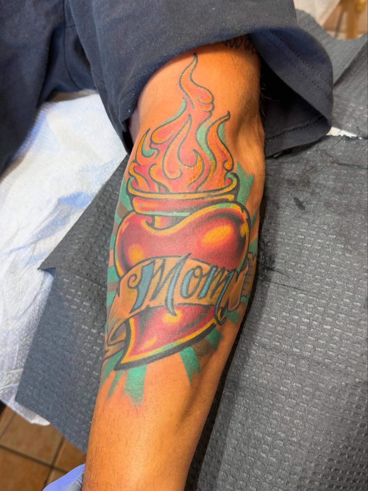 Flaming heart American traditional tattoo on the forearm by Matt Paw