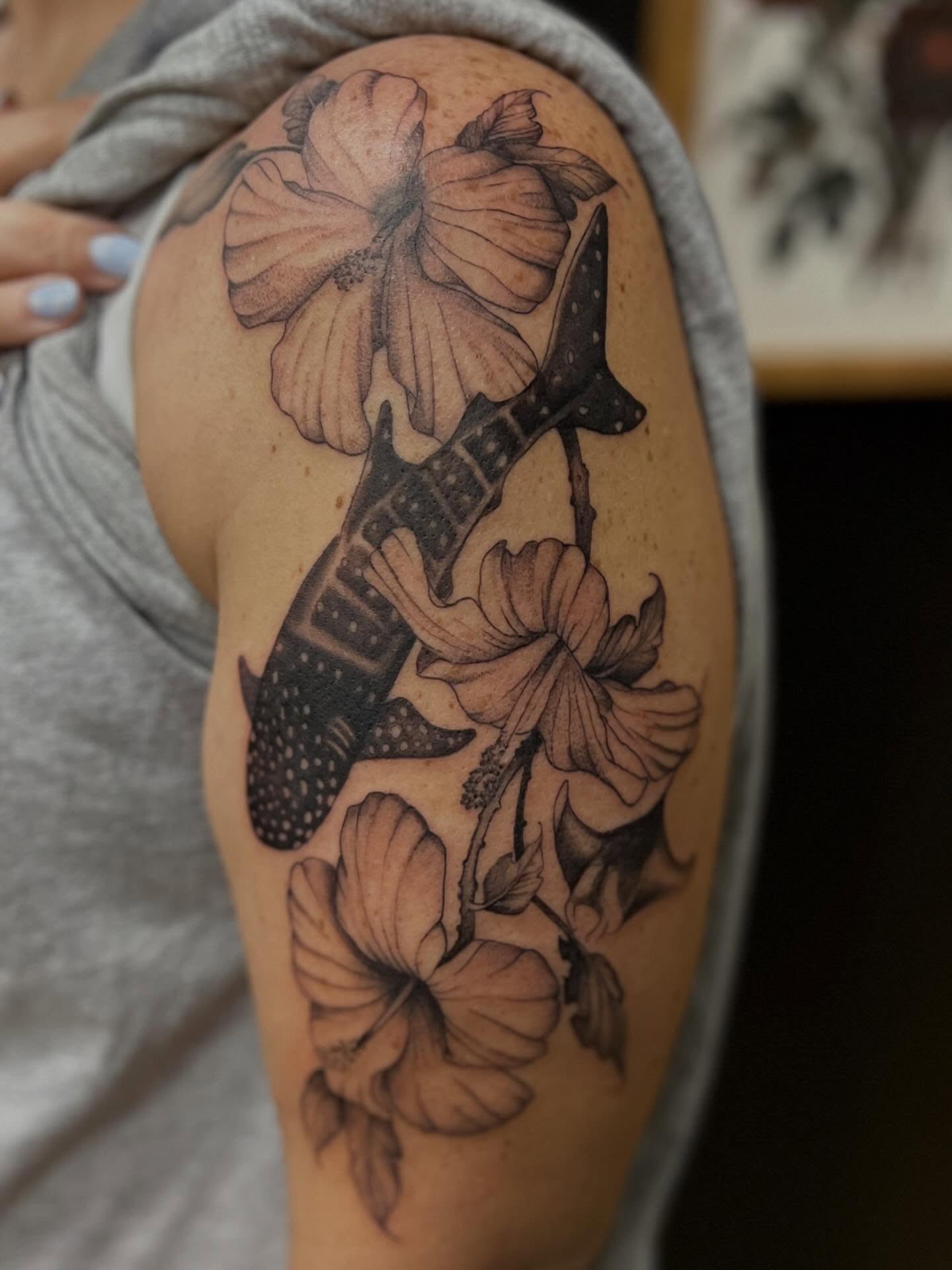 Hawaiian shark and flowers dotwork tattoo on the shoulder by Rebecca Kern Tattoos