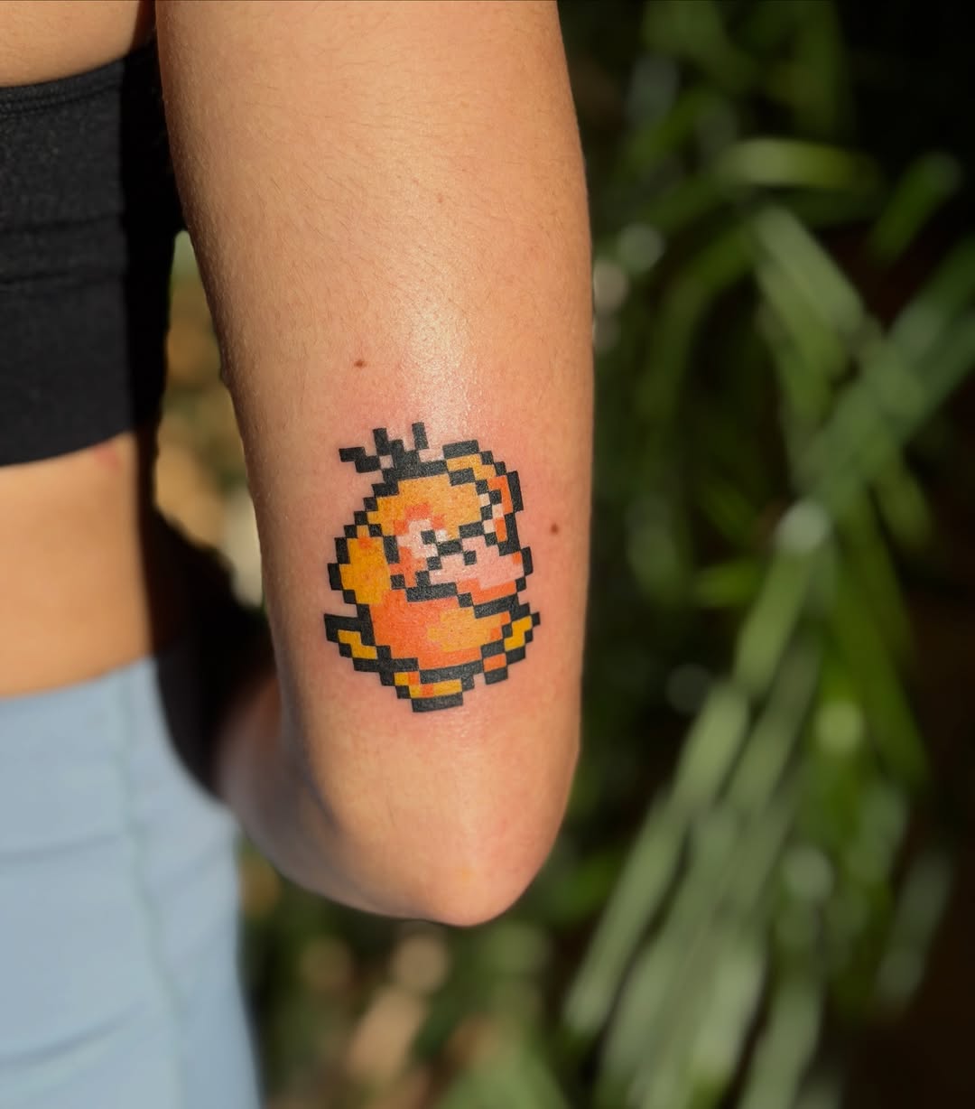 Pixelated Psyduck new school tattoo on the forearm by Fabian💉 Tattoo artist