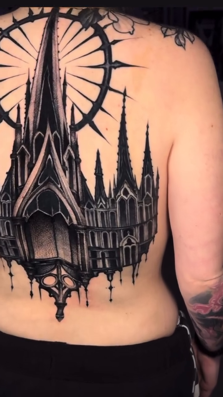 Gothic cathedral with sunburst dark art tattoo on the back by miami tattoo artist