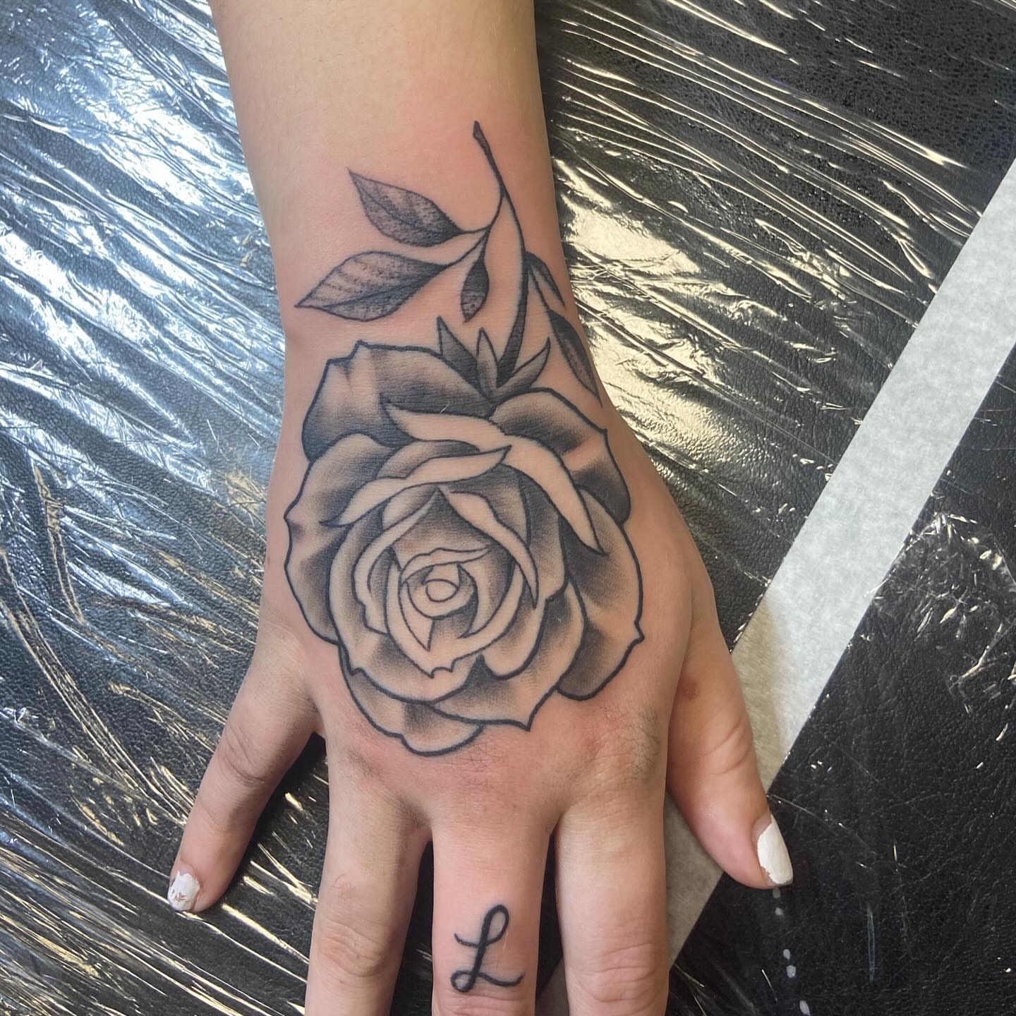 Rose black and grey tattoo on the hand by Sam Hearnen, Lawrence, Kansas