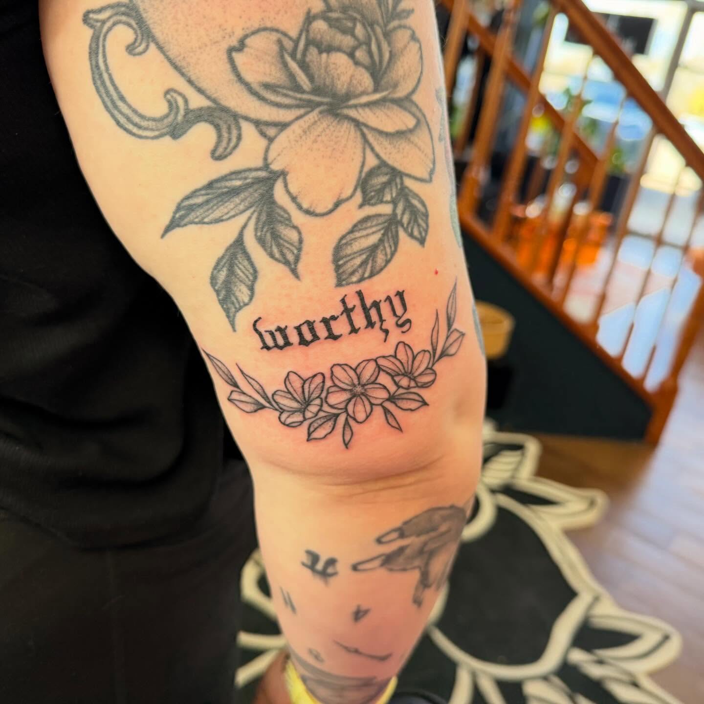 Flower and script black and grey tattoo on the forearm by Erica Rose π€