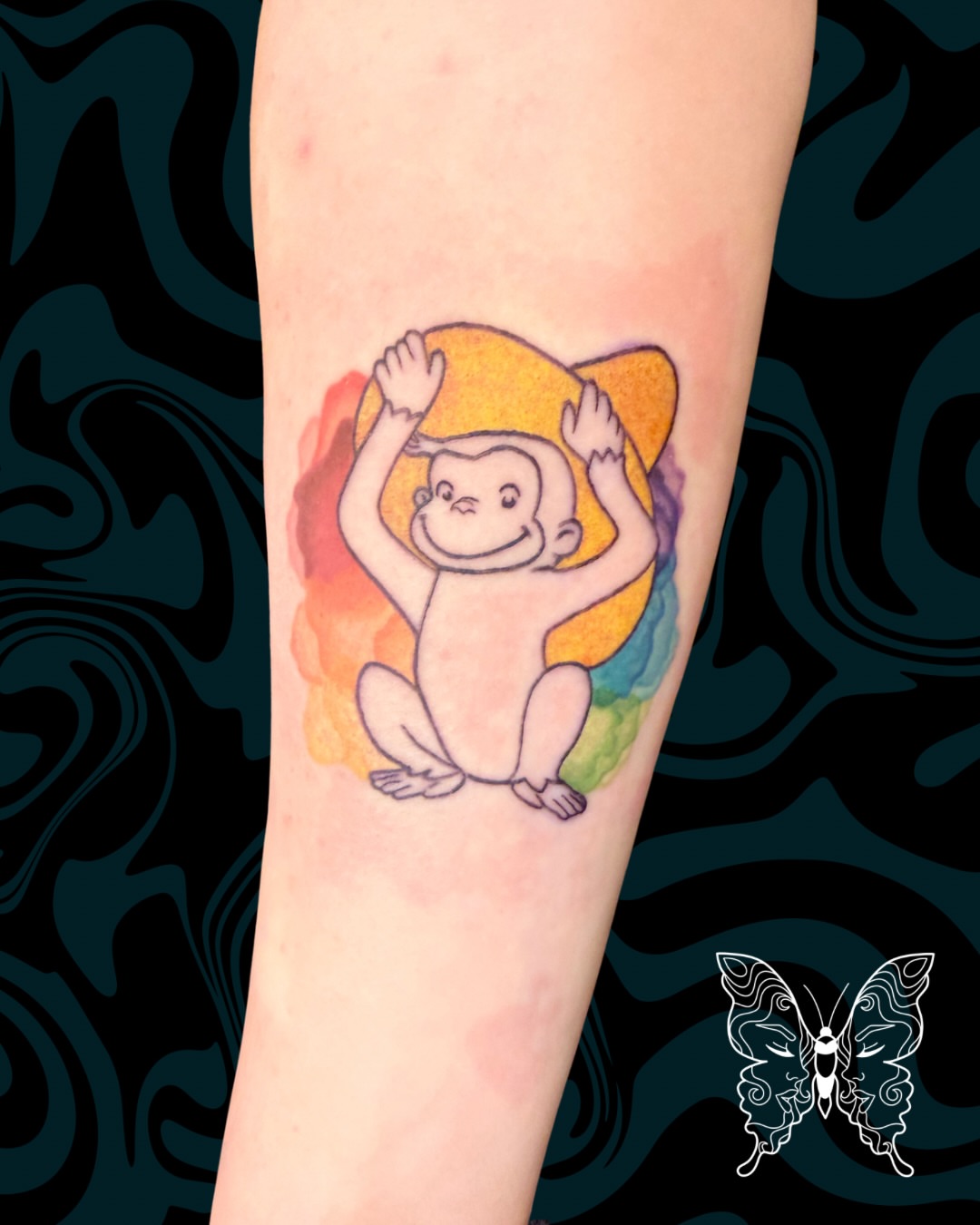 Curious george monkey watercolor tattoo on the forearm by Nicci
