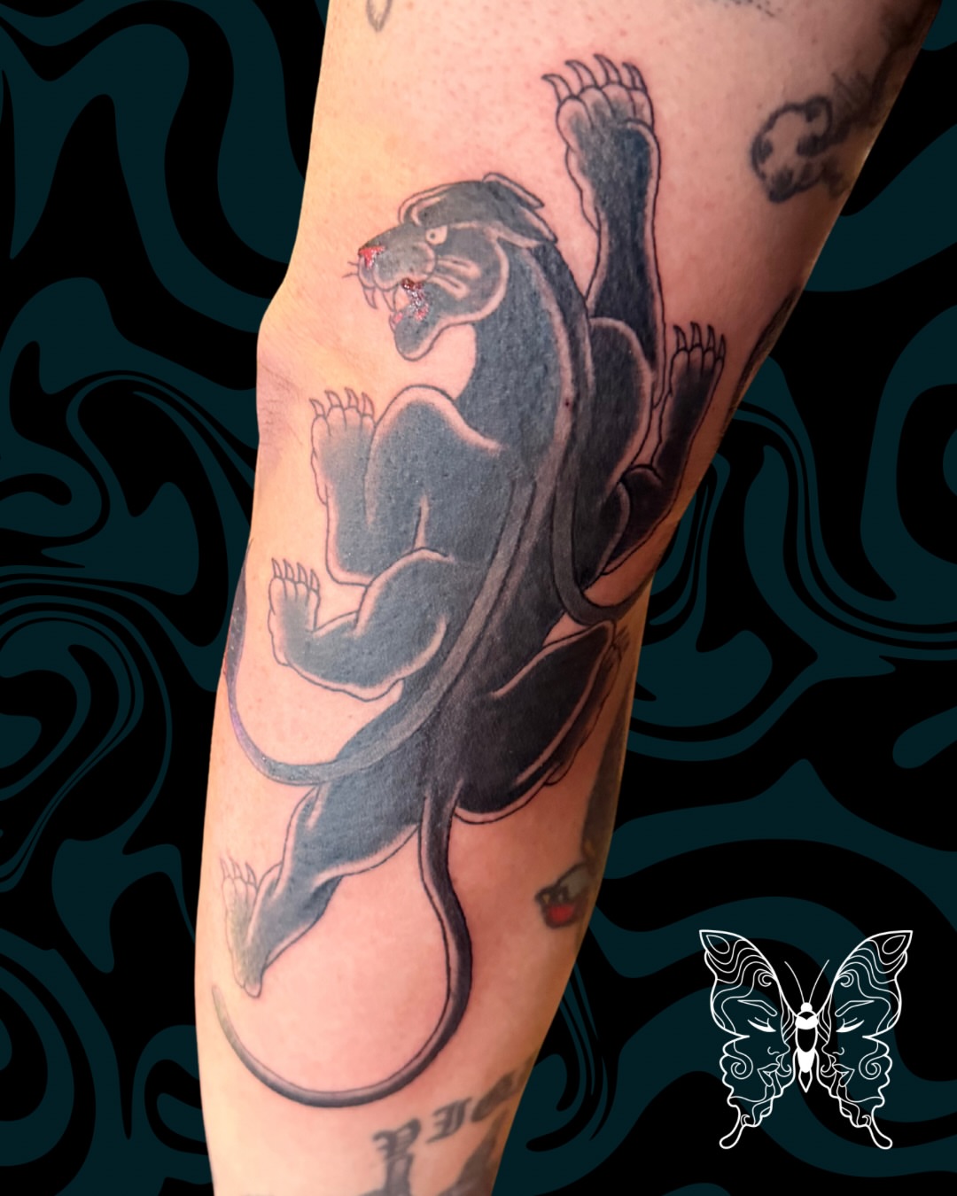 Panther black and grey tattoo on the forearm by Nicci