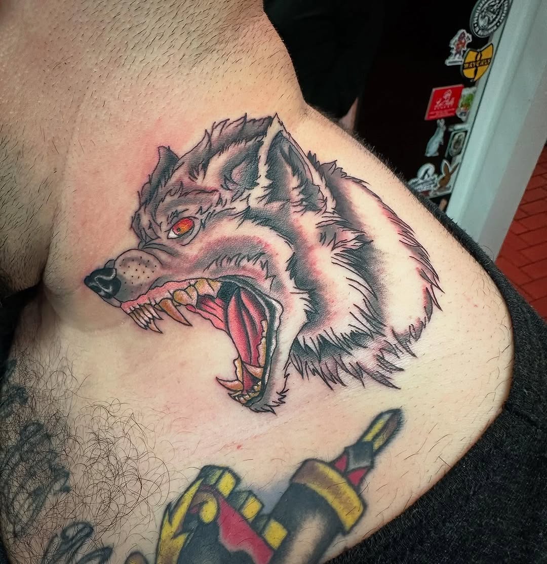 Wolf head realism tattoo on the chest by Greyson Heidenreich