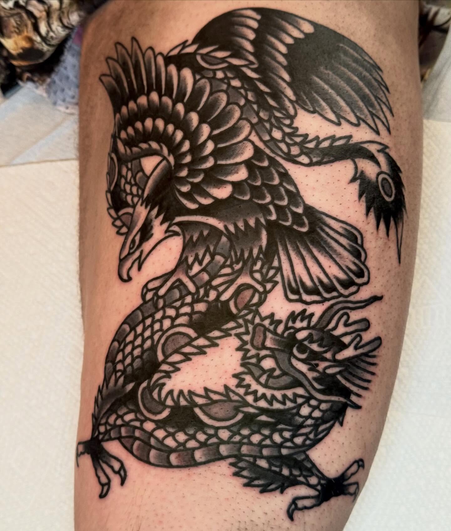 Dragon and phoenix American traditional tattoo on the thigh by Eli Bernal
