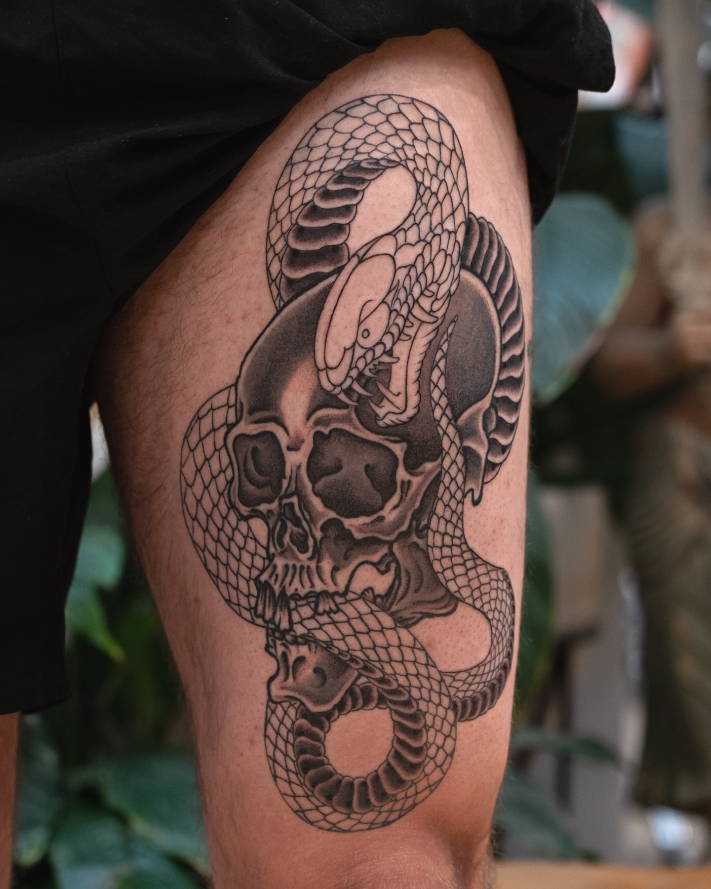 Snake and skull realism tattoo on the thigh by James Fernella, San Francisco, California