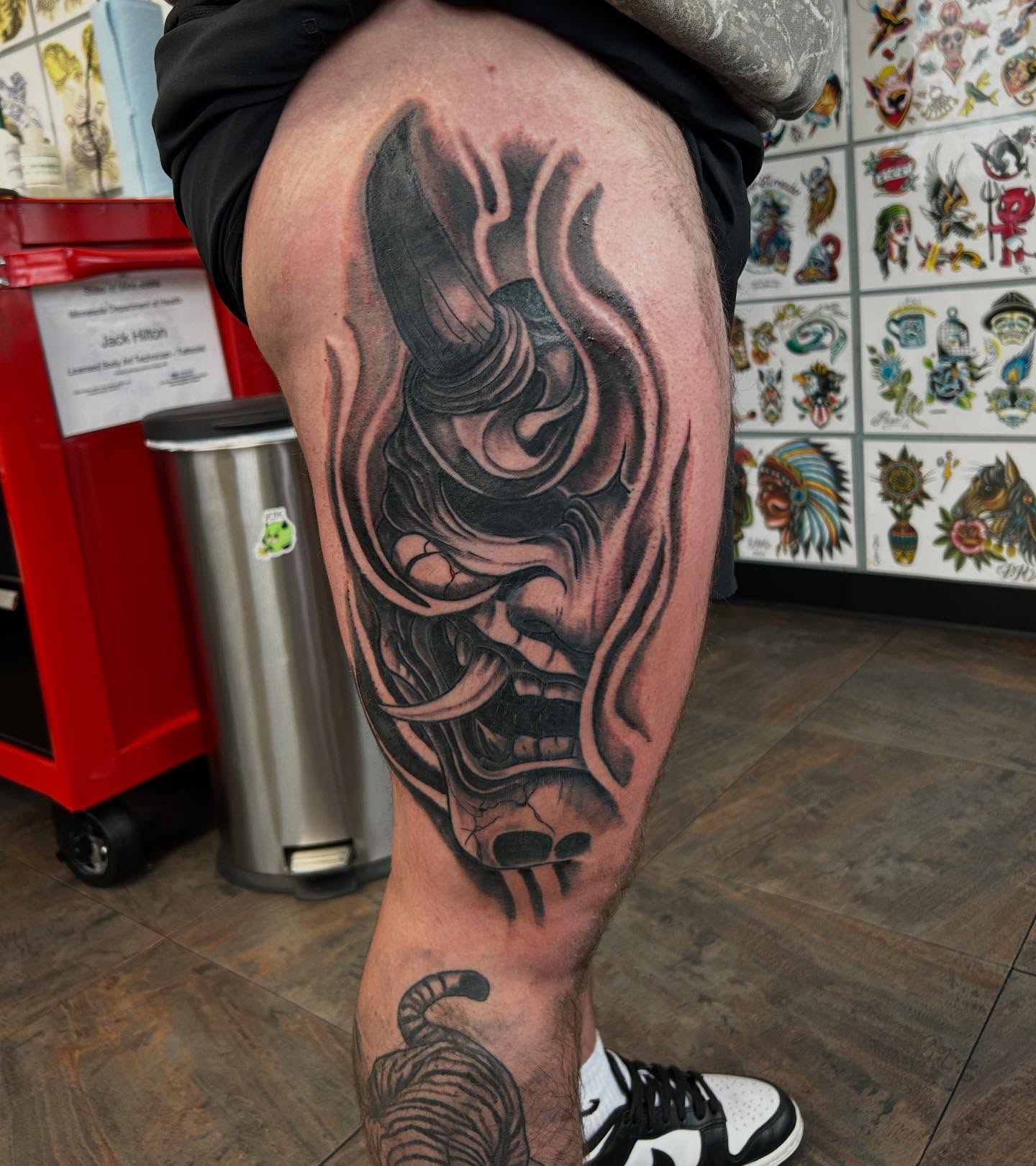 Mask dark realism tattoo on the thigh by Randy Bray