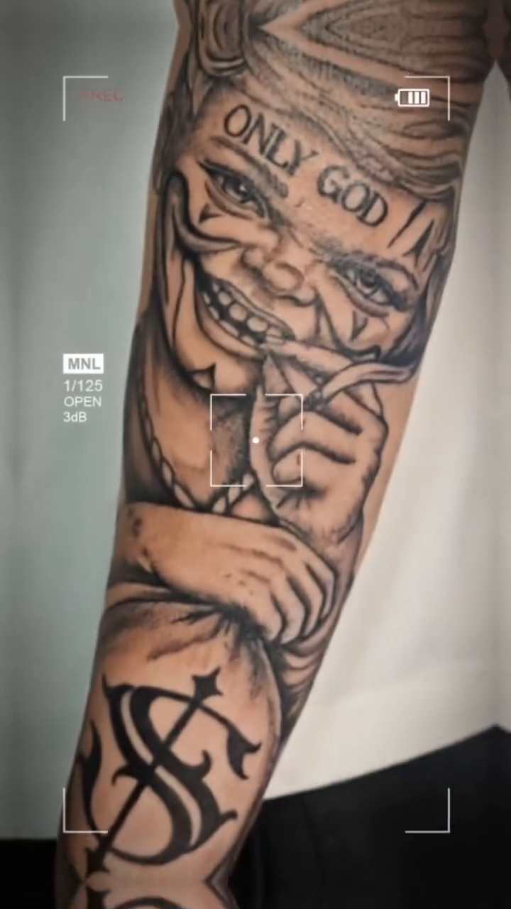 Clown with money bag realism tattoo on the forearm by Juanma Martin