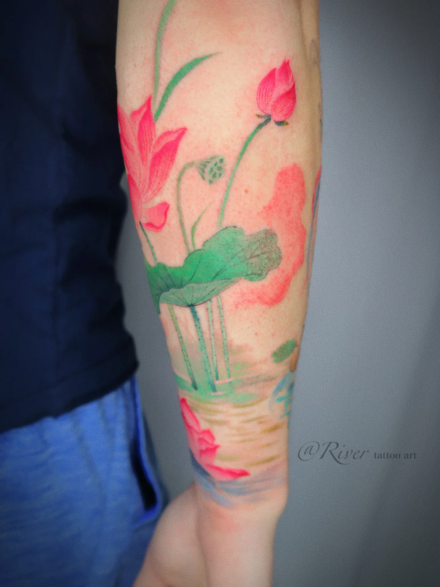 Lotus flowers watercolor tattoo on the forearm by River