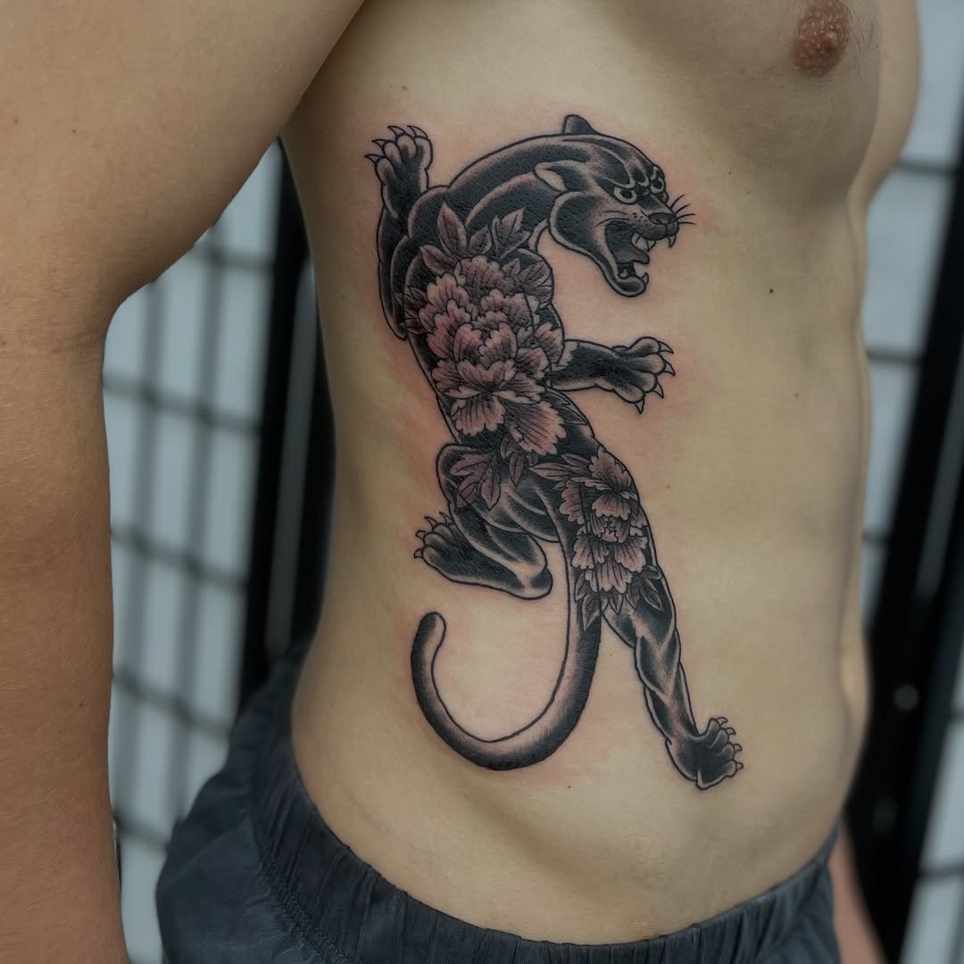 Panther and peonies realism tattoo on the ribs by Mister Joe Joe Frisco Tattoo, San Francisco, California