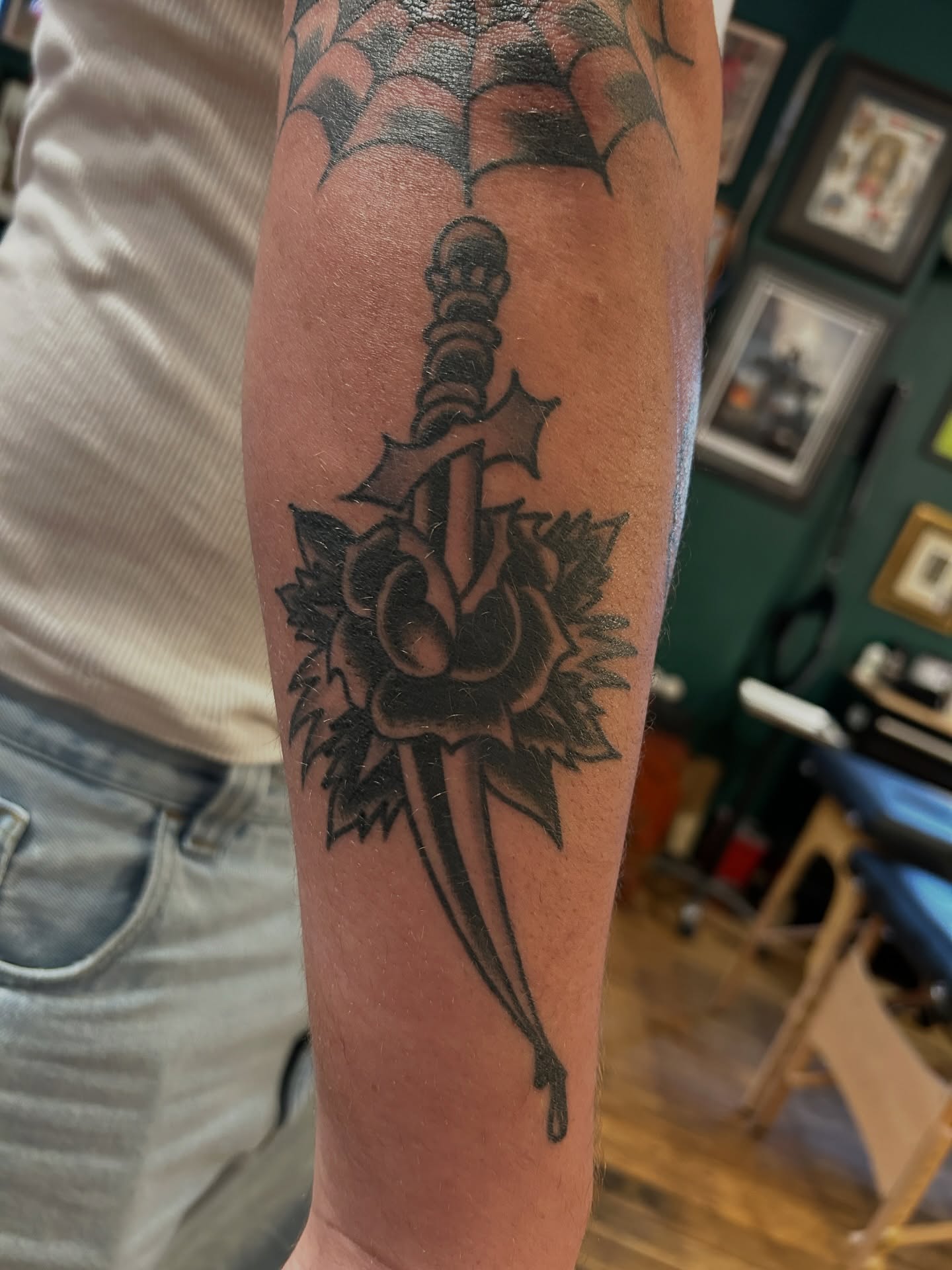 Sword and flower black and grey tattoo on the forearm by Eric Caudill, Indianapolis, Indiana