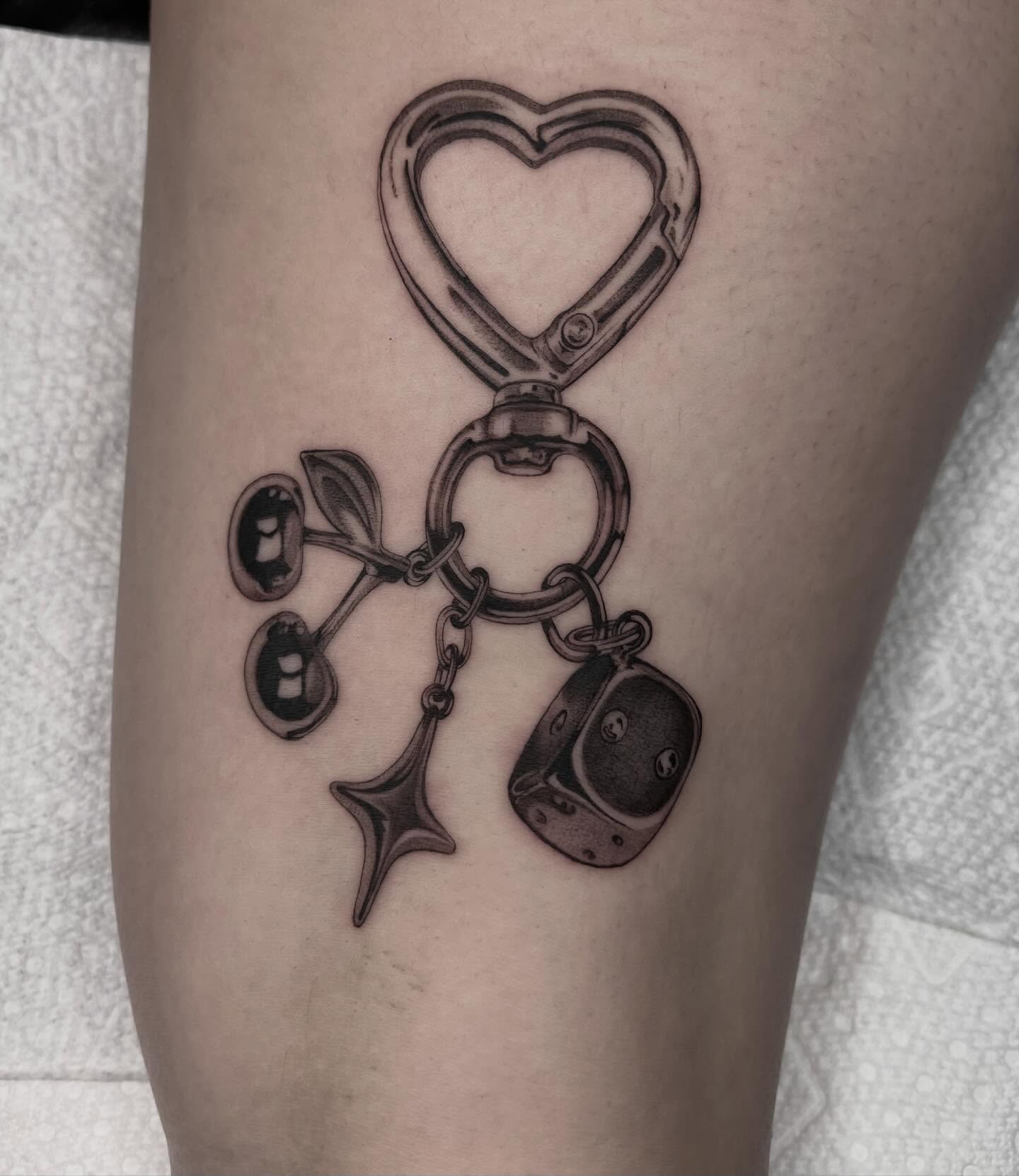 Handcuffs and dice black and grey tattoo on the forearm by Kayla Faircloth, Charlotte, North Carolina