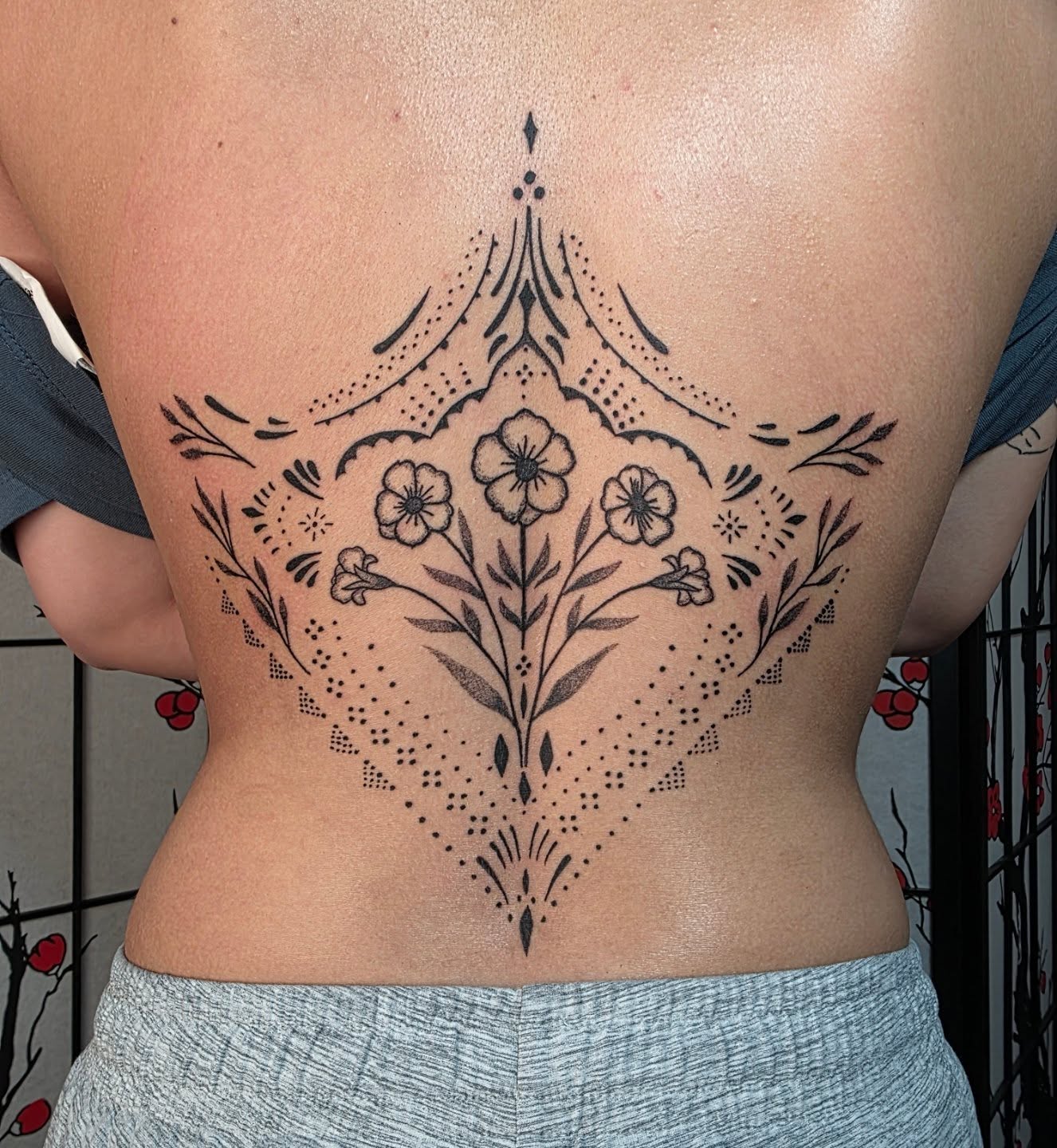 Floral mandala dotwork tattoo on the back by Bryan "Yogi" Fuhs