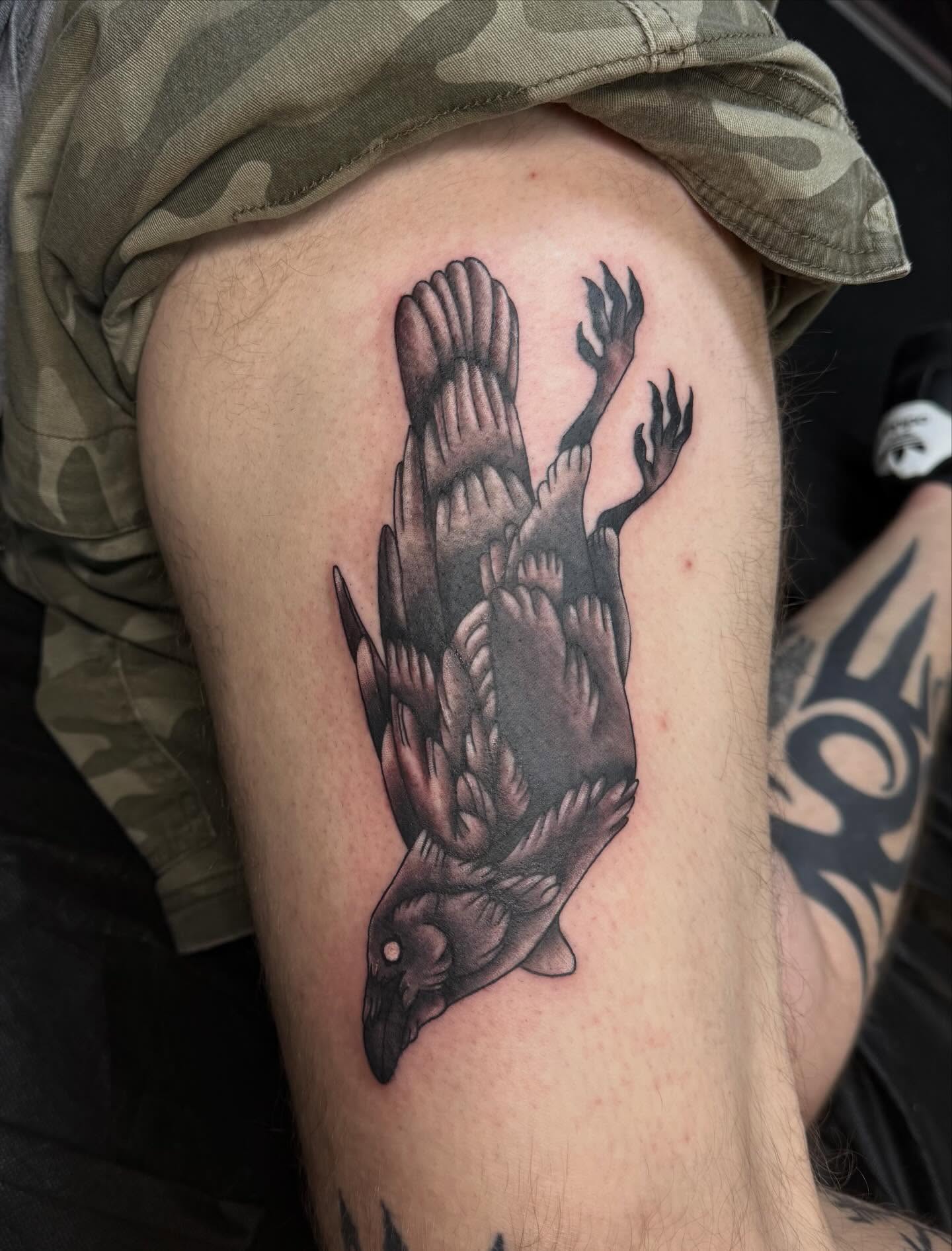 Crow black and grey tattoo on the thigh by Nic