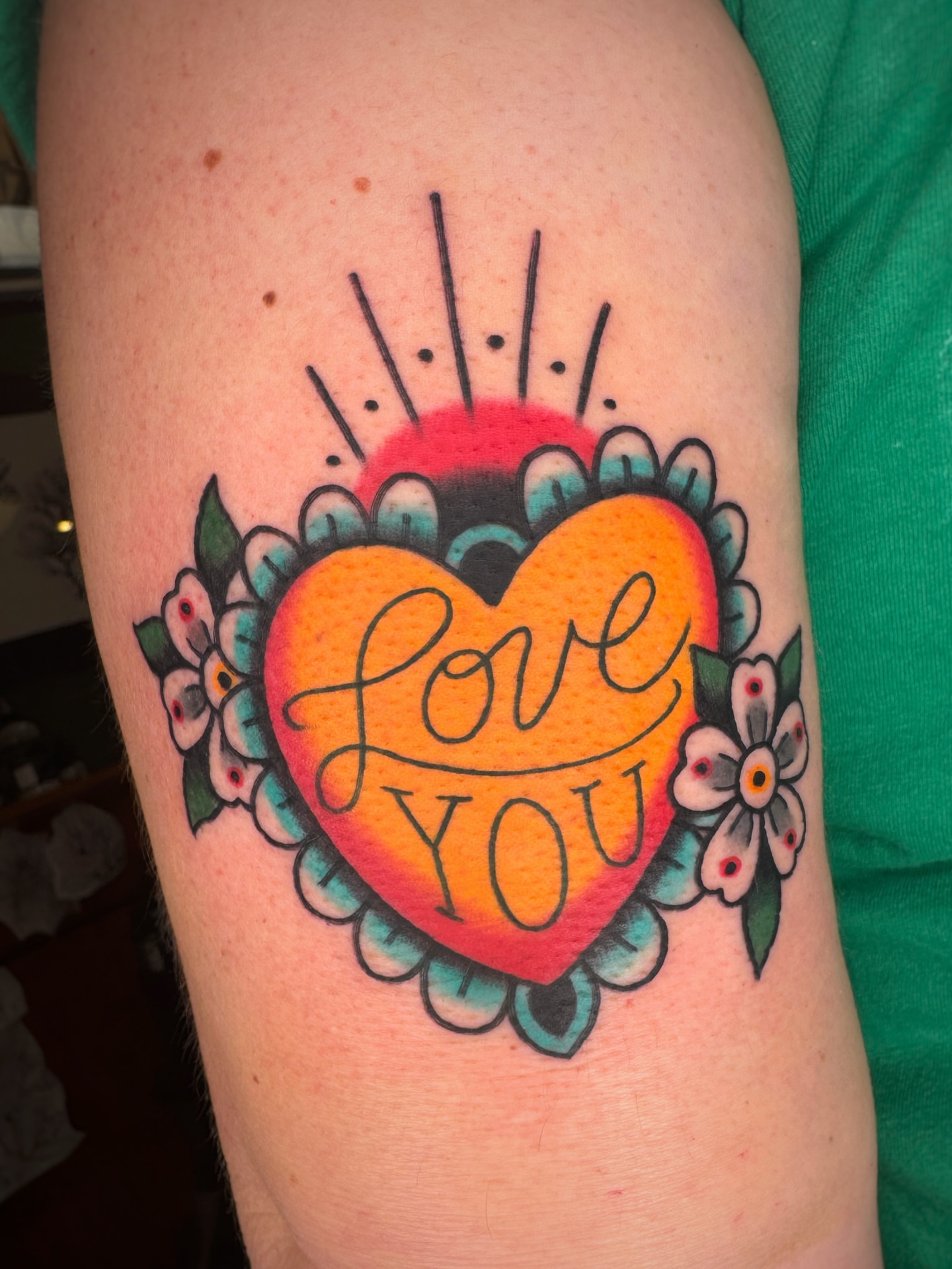 Heart with 'love you' American traditional tattoo on the forearm by Cori James Tattoo Artist