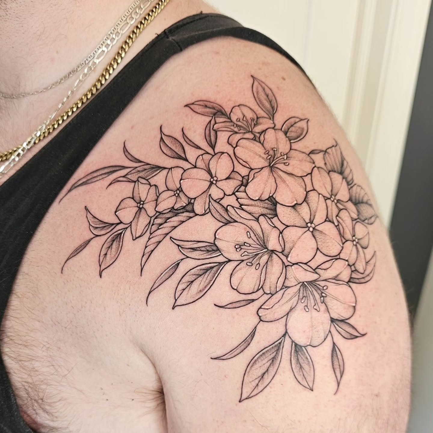 Flower bouquet black and grey tattoo on the shoulder by Dani Bond