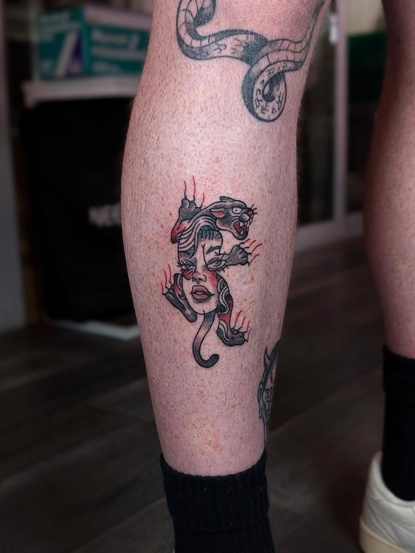 Woman with snake American traditional tattoo on the calf by ᴇʟɪsᴇ