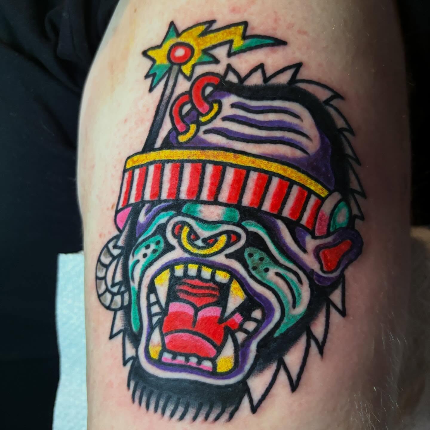 Jester head American traditional tattoo on the forearm by Mitch Ashpaugh