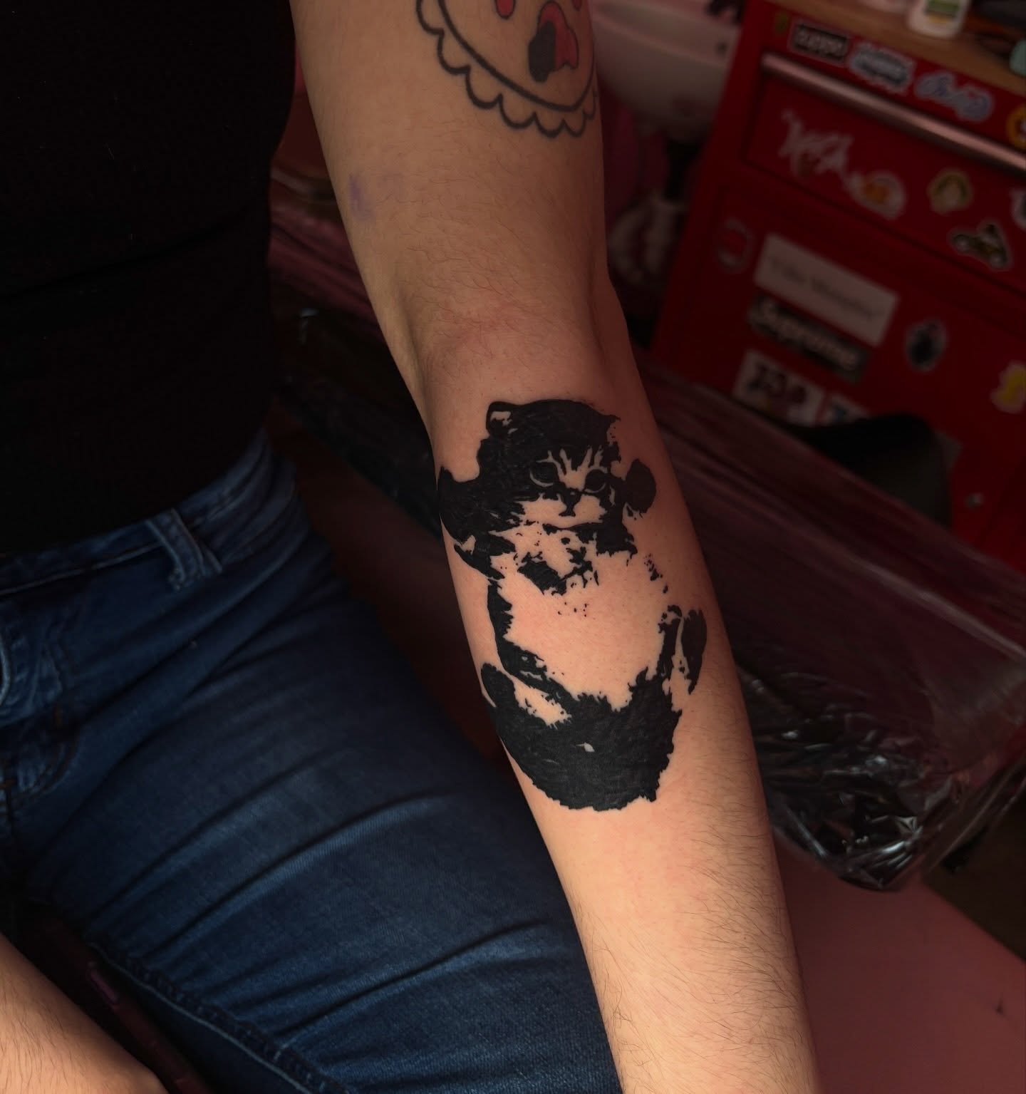 Cat black and grey tattoo on the forearm by neal