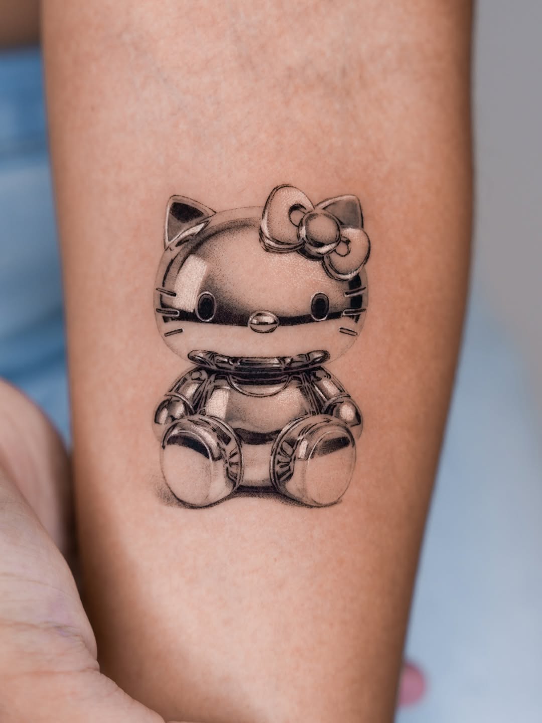 Robot hello kitty realism tattoo on the forearm by Jun