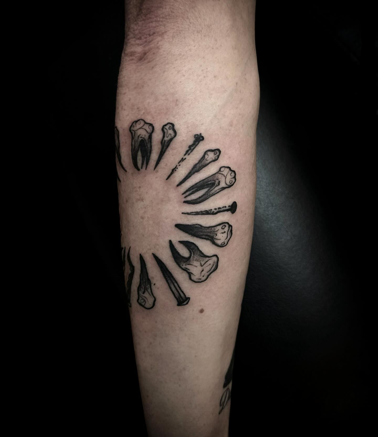 Bones and nails black and grey tattoo on the forearm by 𝕽𝖎𝖌𝖊𝖗𝖘 𝕳𝖆𝖒𝖟𝖆, San Francisco, California