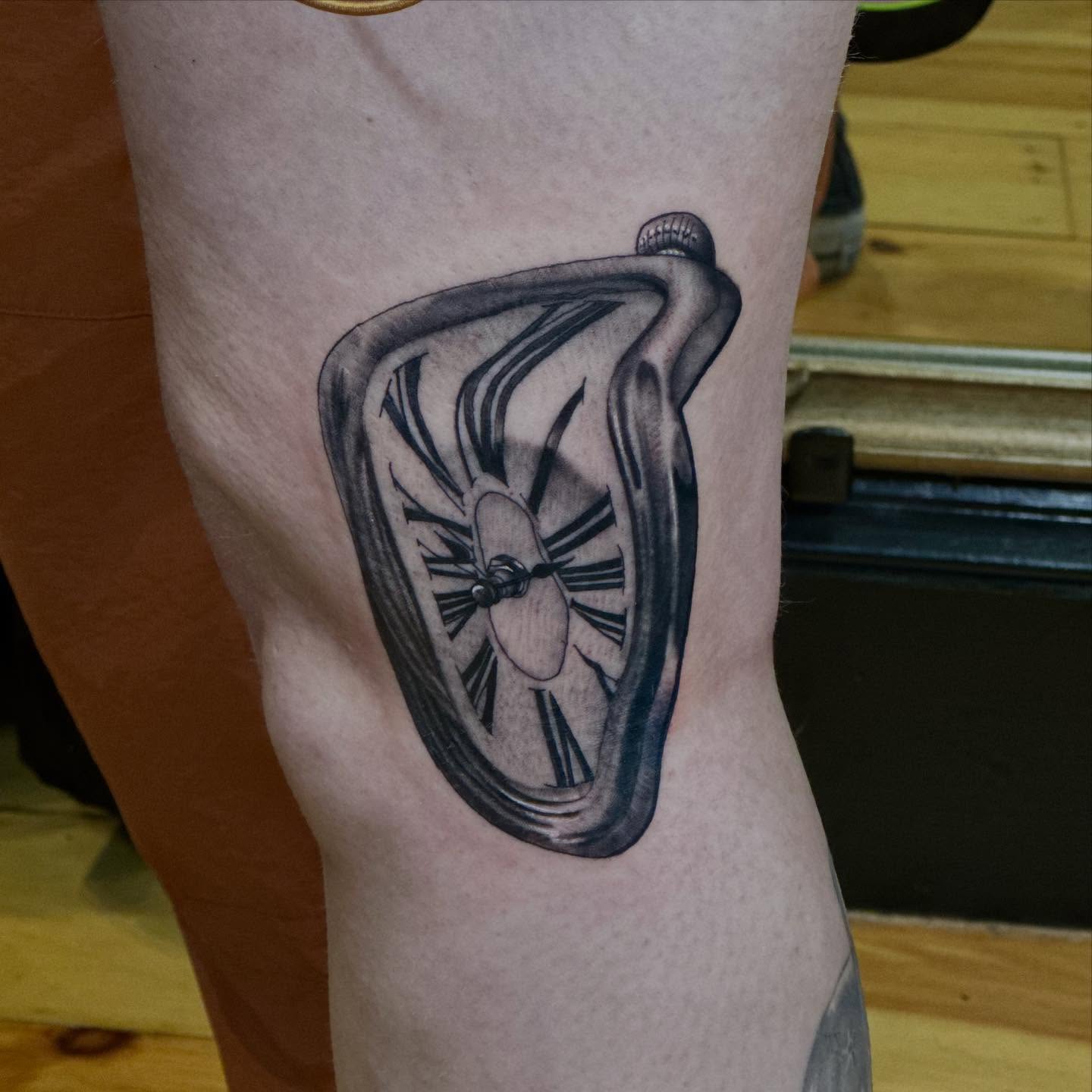 Melting clock realism tattoo on the forearm by Dylan Curry