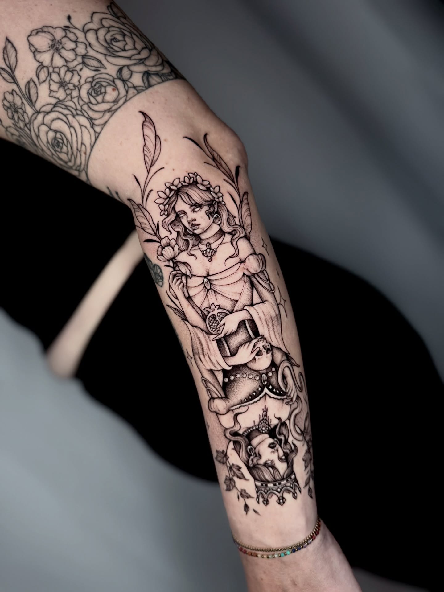 Woman with bird black and grey tattoo on the forearm by Kathryn Semus