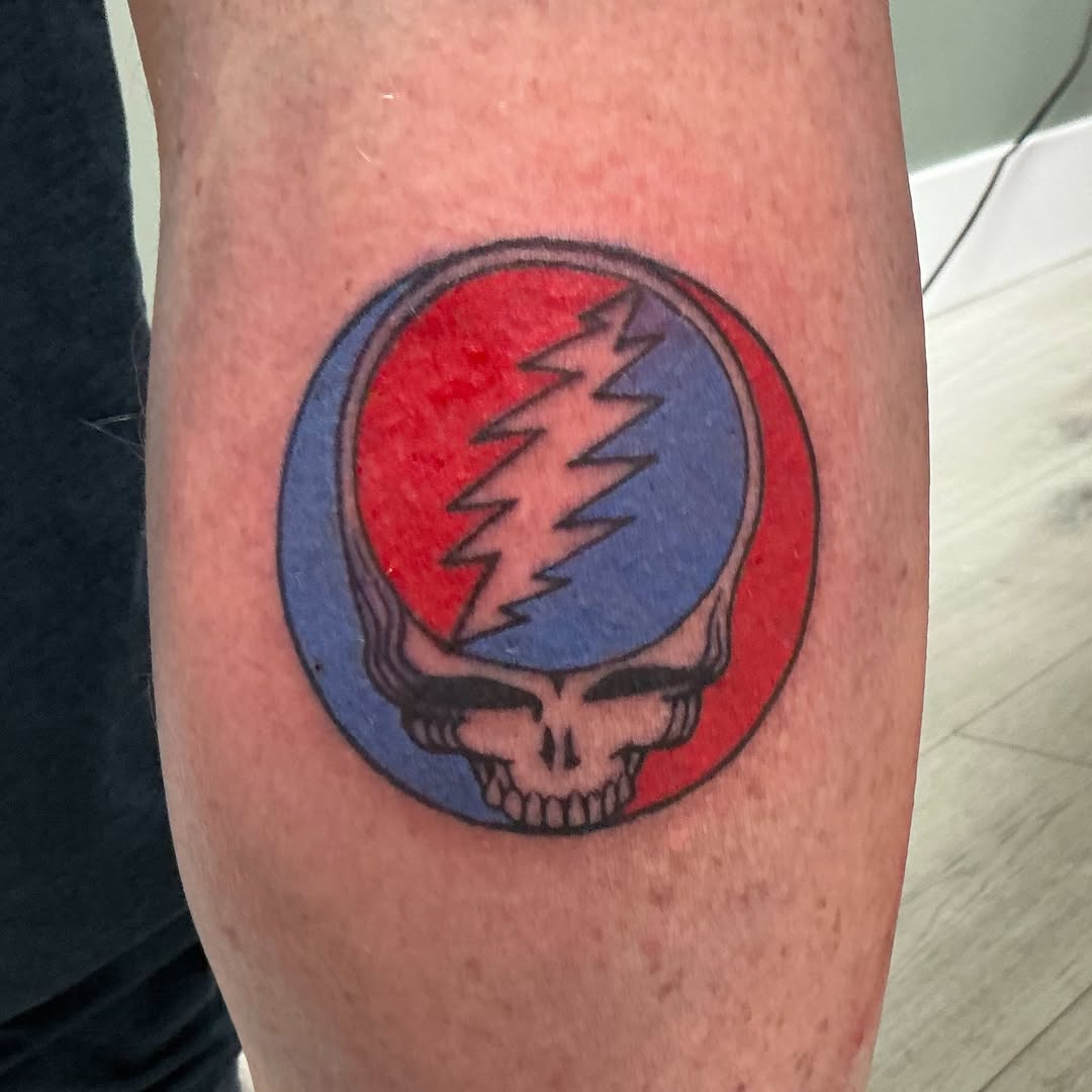 Steal Your Face skull American traditional tattoo on the forearm by Isaac Mccavitt