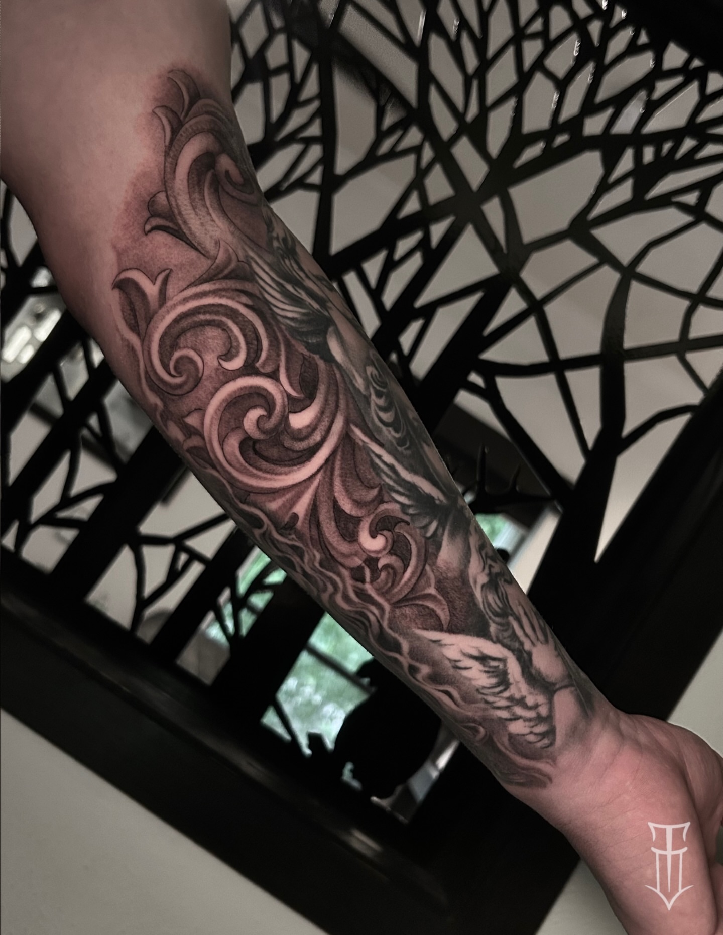 Swirls and floral ornamental tattoo on the forearm by Tyler Osburn