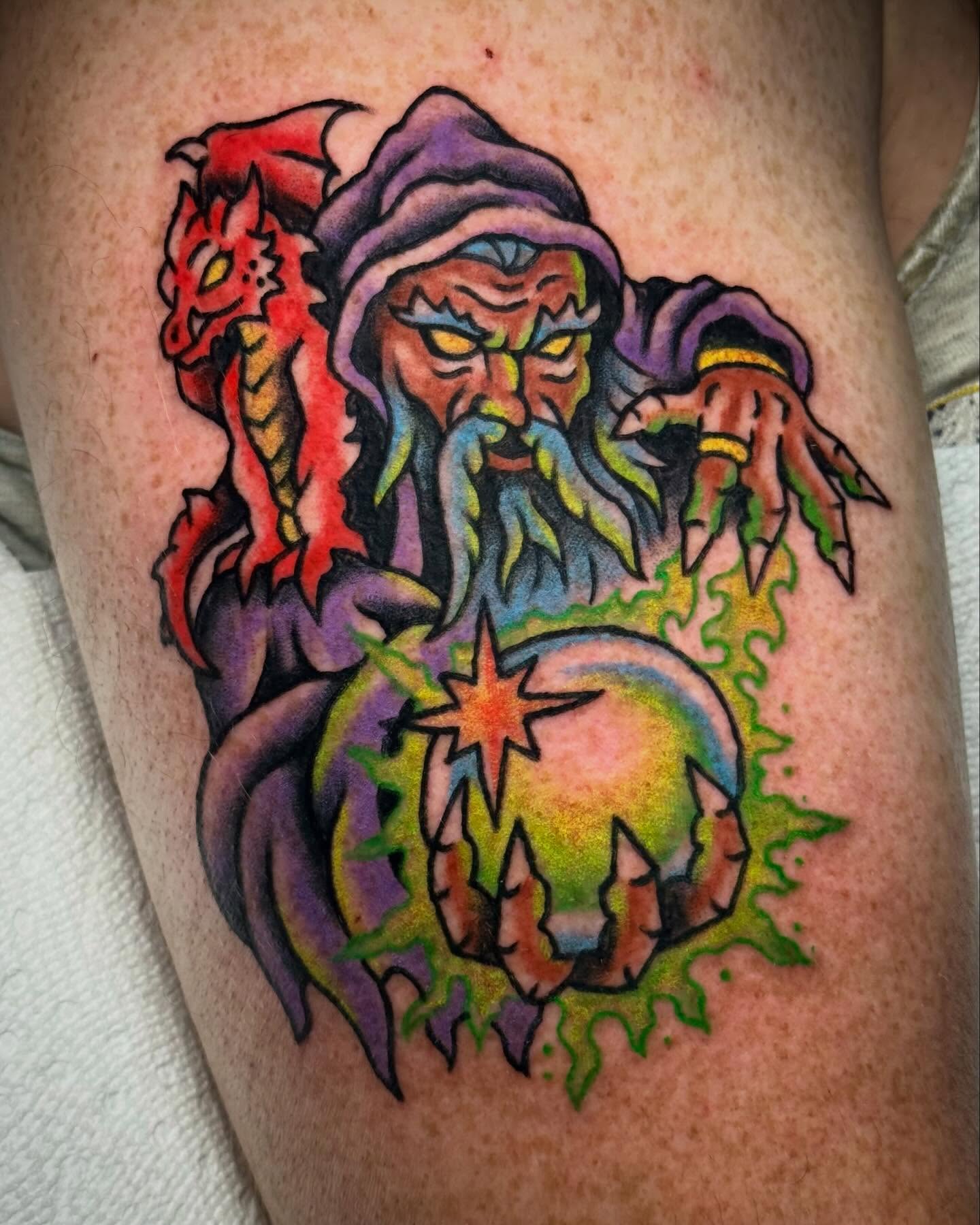 Wizard and dragon American traditional tattoo on the thigh by Ty Elias