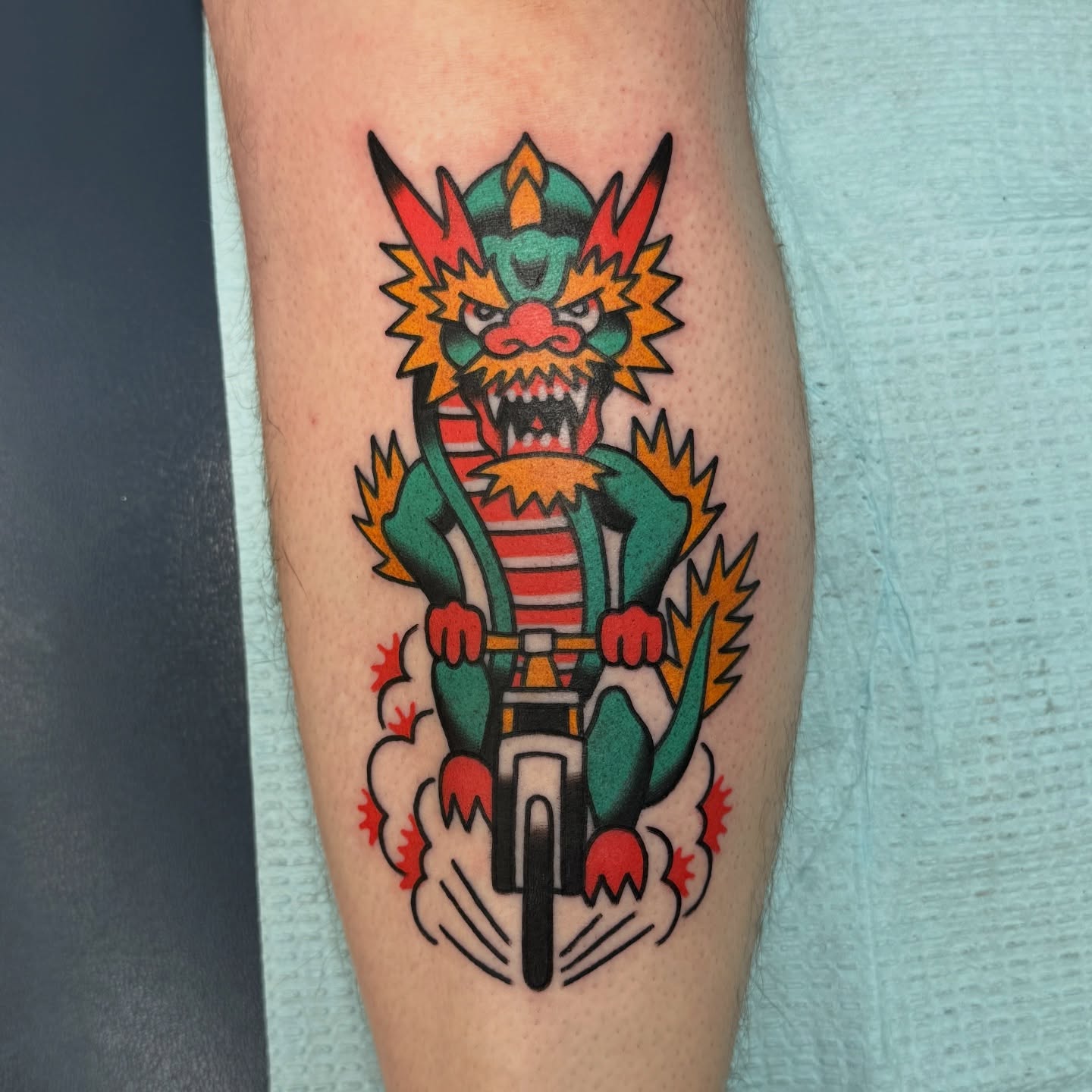 Demon riding bicycle American traditional tattoo on the forearm by Sam