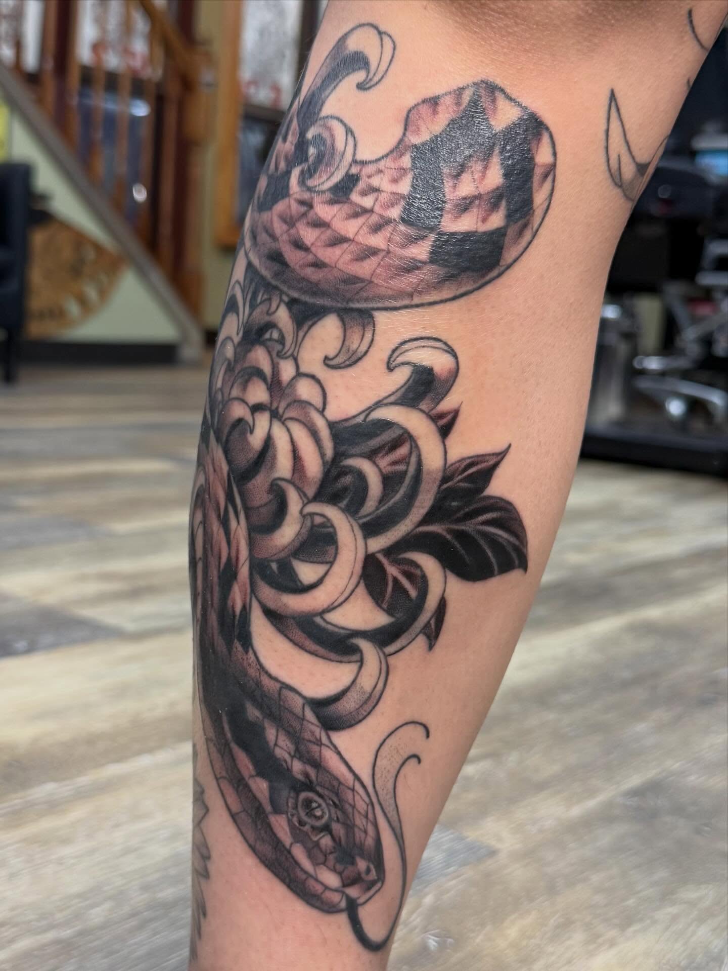 Snake and peony American traditional tattoo on the forearm by Eli
