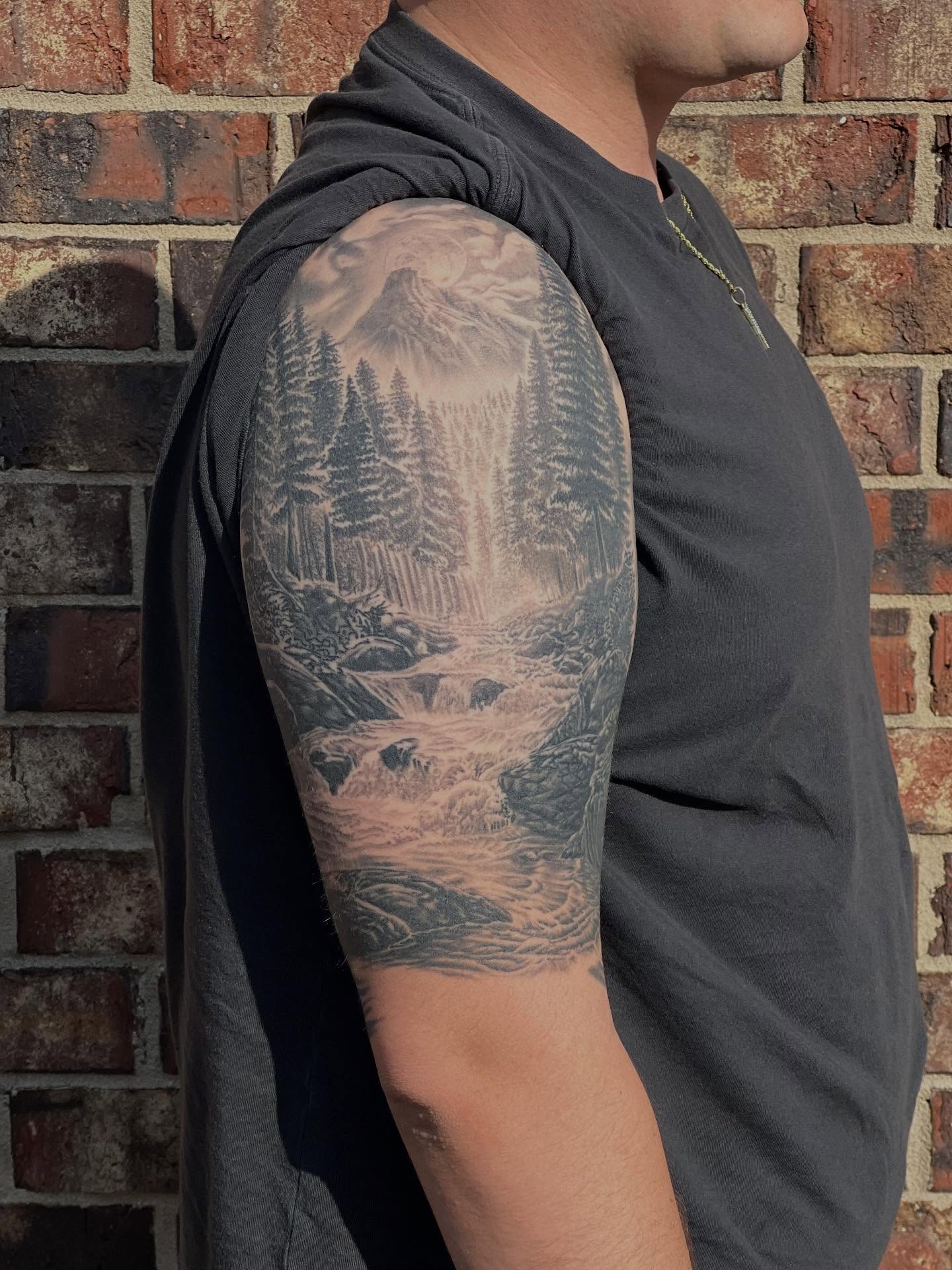 Mountain landscape realism tattoo on the upper arm by Lord Daniel Serna