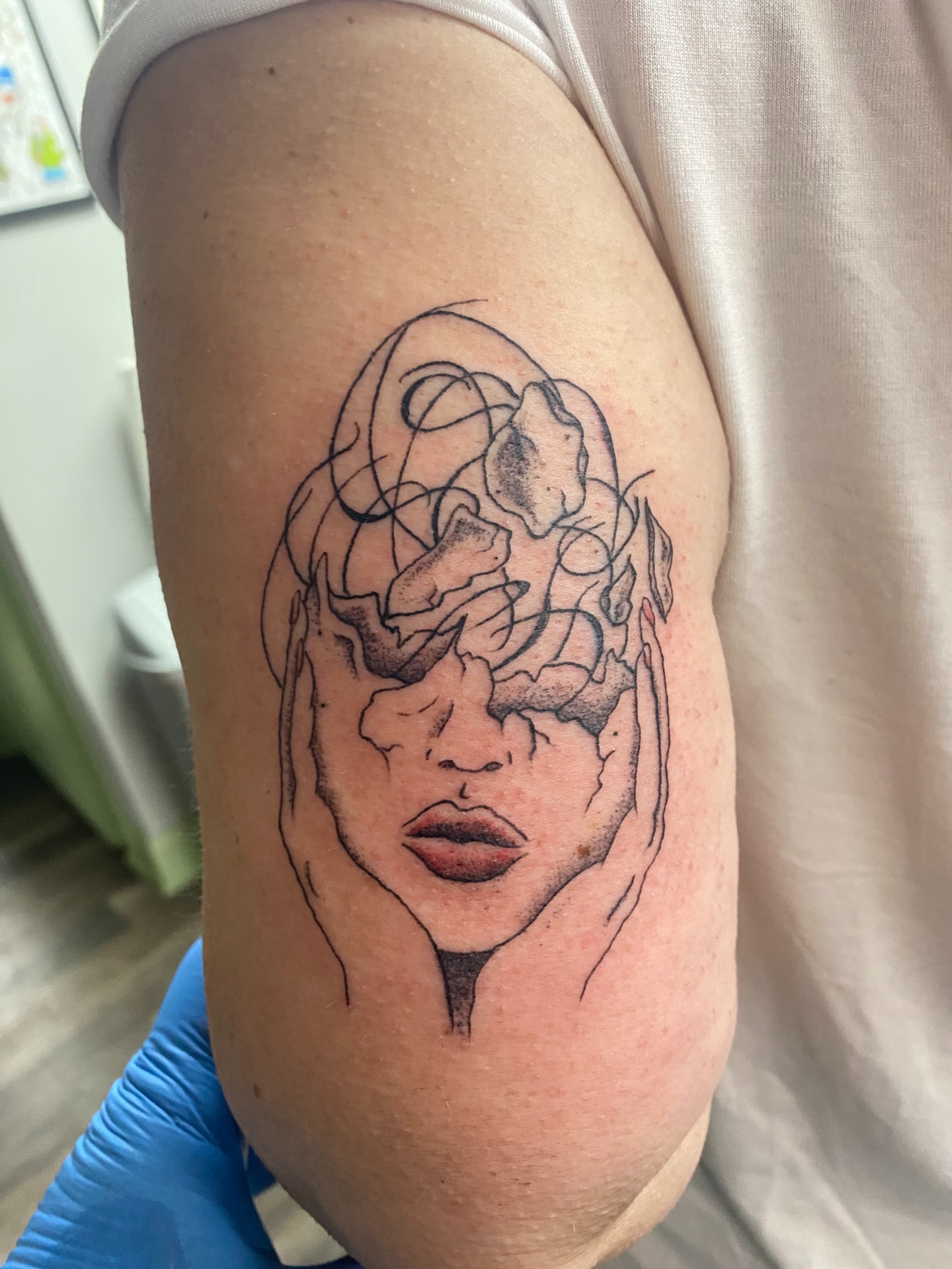 Abstract face black and grey tattoo on the upper arm by Giuseppe T.C.