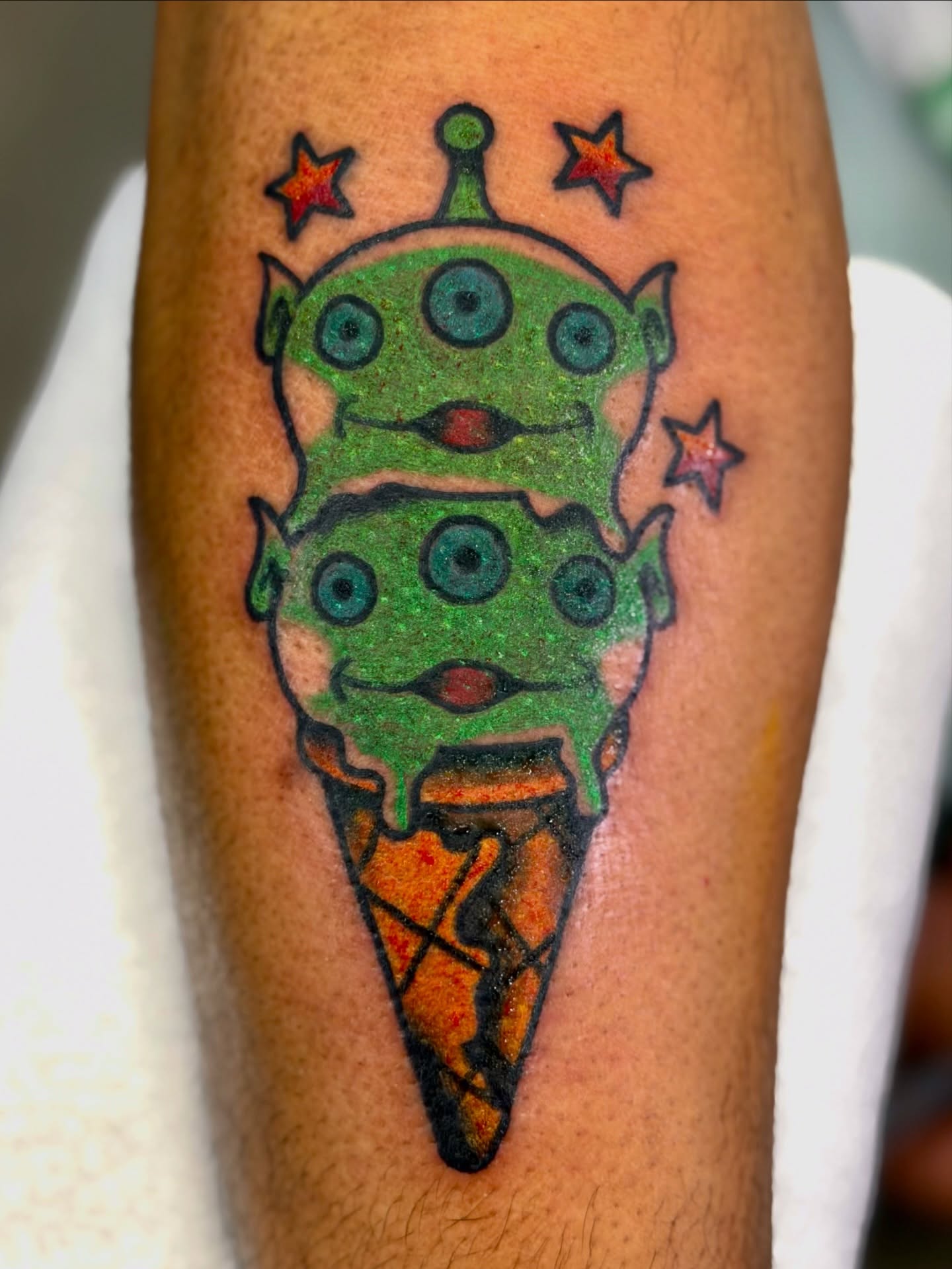 Alien ice cream cone new school tattoo on the forearm by Javin Klingelhoefer Mosley