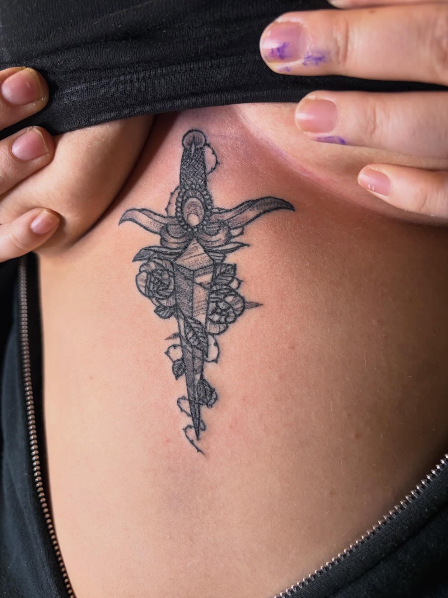 Sword and roses black and grey tattoo on the chest by Sum'er Daize Tattoos
