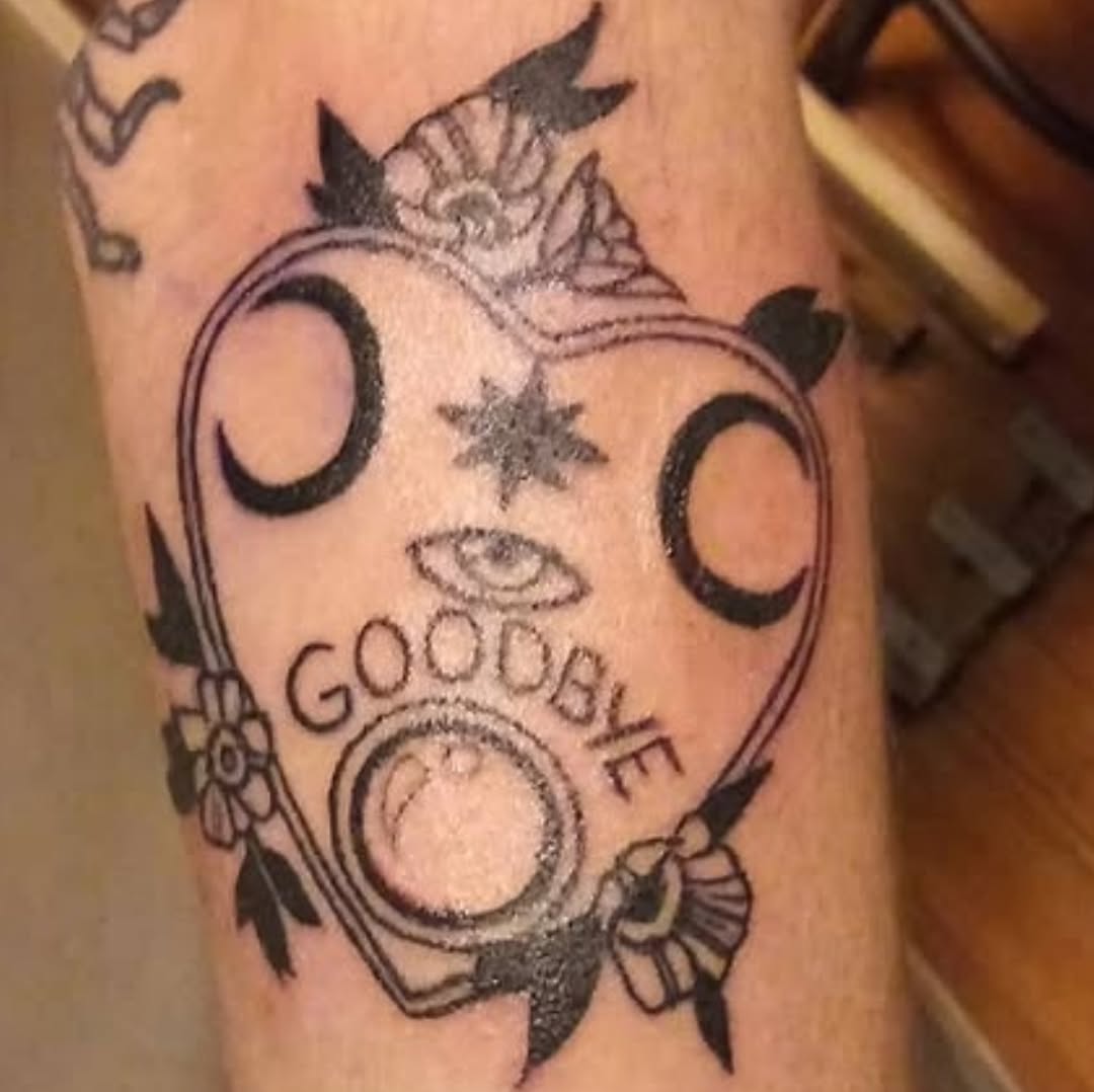 Ouija board with moons and flowers tattoo on the forearm by Amber