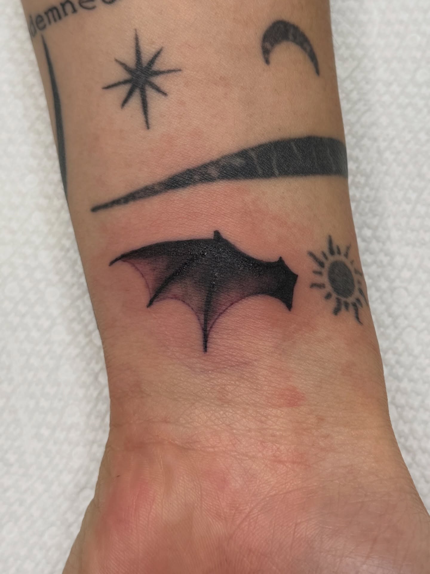 Bat wings black and grey tattoo on the forearm by Andre Guerra