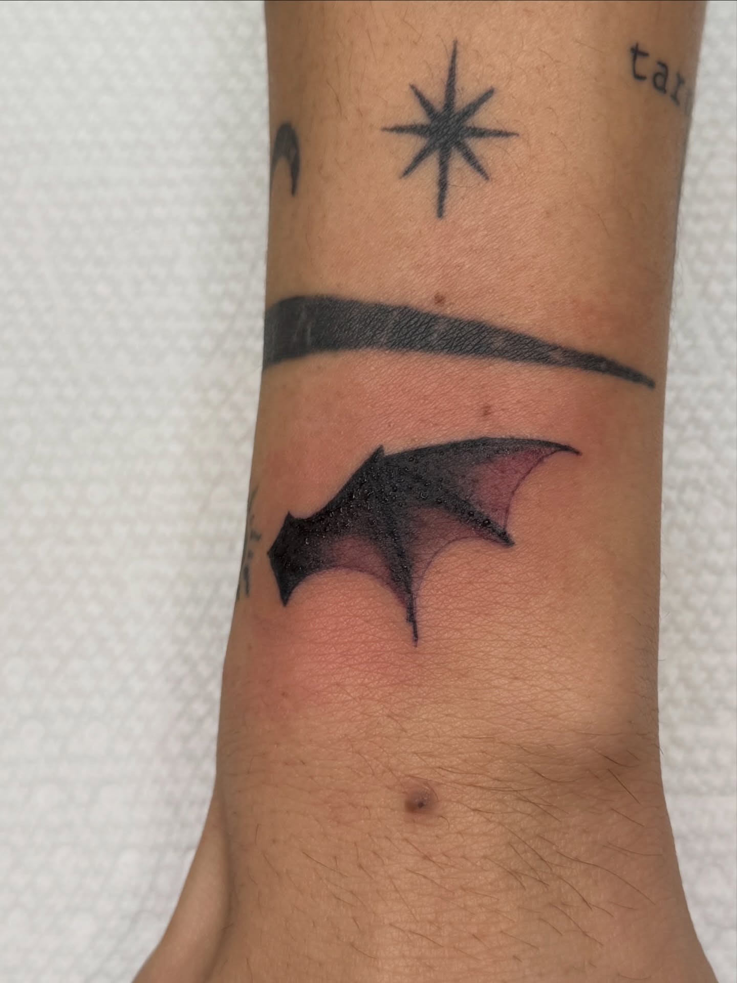 Bat black and grey tattoo on the forearm by Andre Guerra